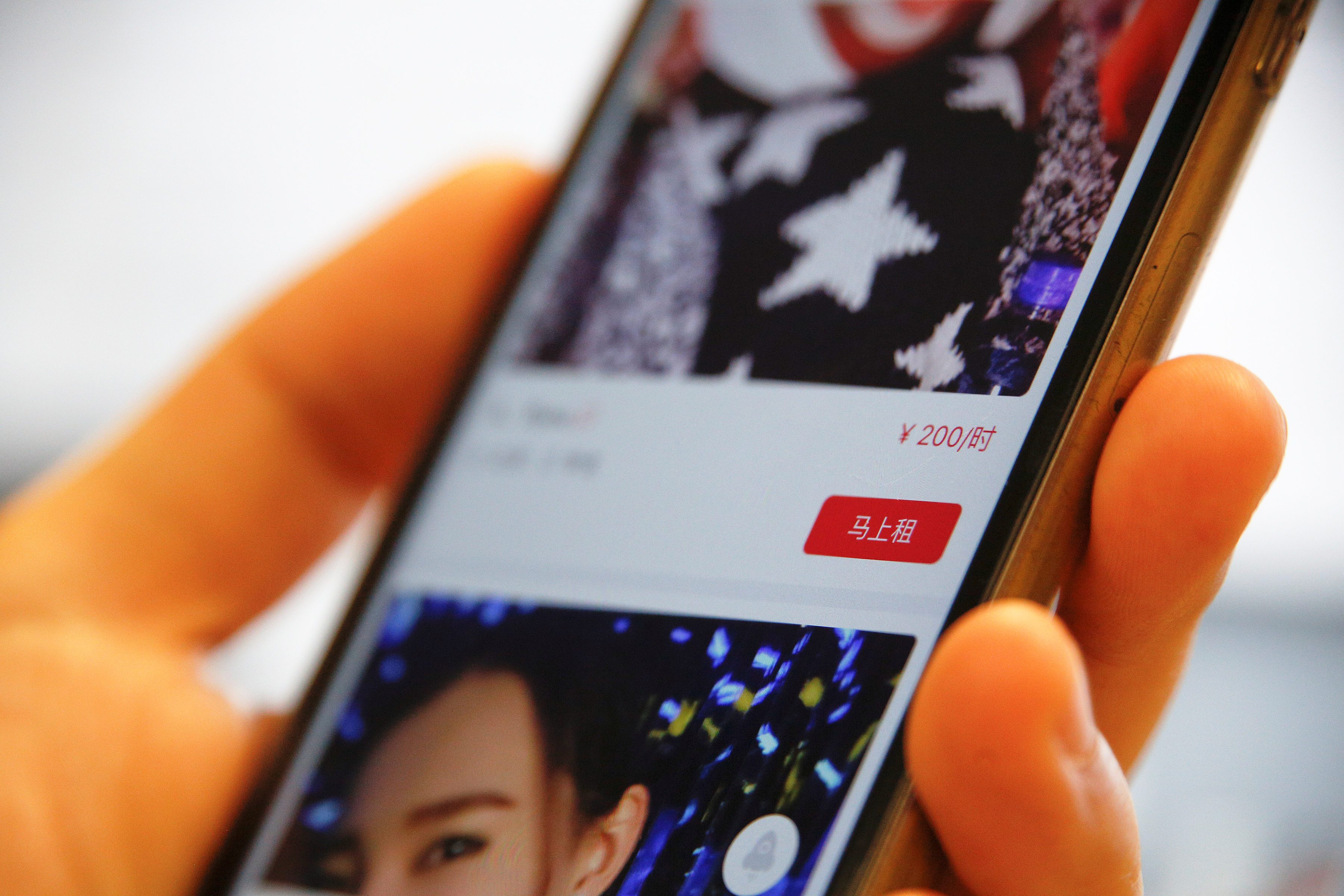 A page of a date-hiring app "Hire Me Plz", which says "rent now for 200 yuan an hour", is shown in this picture illustration in Beijing, China, January 26, 2017. REUTERS/Damir Sagolj/Illustration