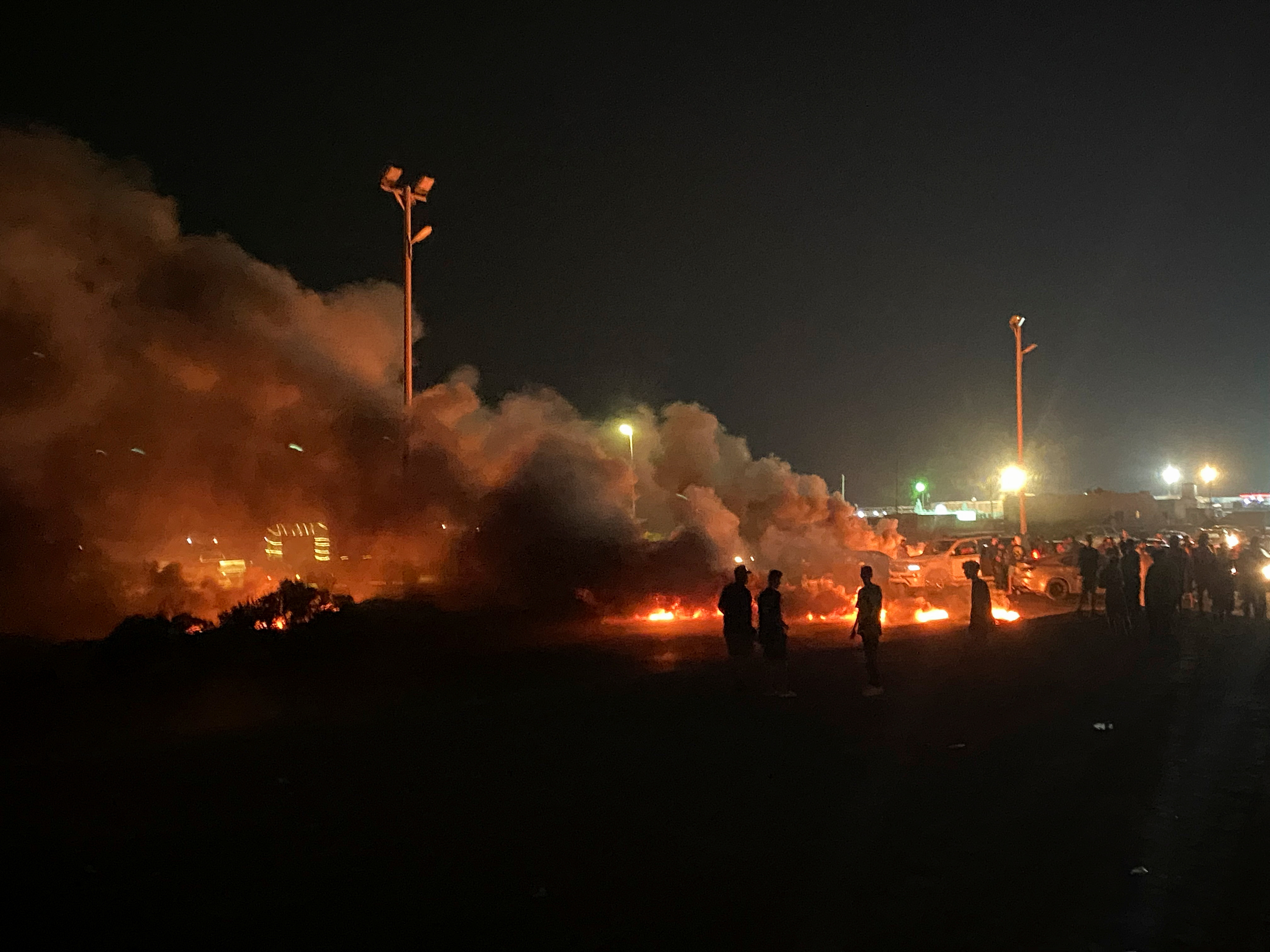 Demonstrators burn tires in protest against the meeting which was held last week in Italy between foreign affairs ministers of Libya and Israel, in Tripoli, Libya.