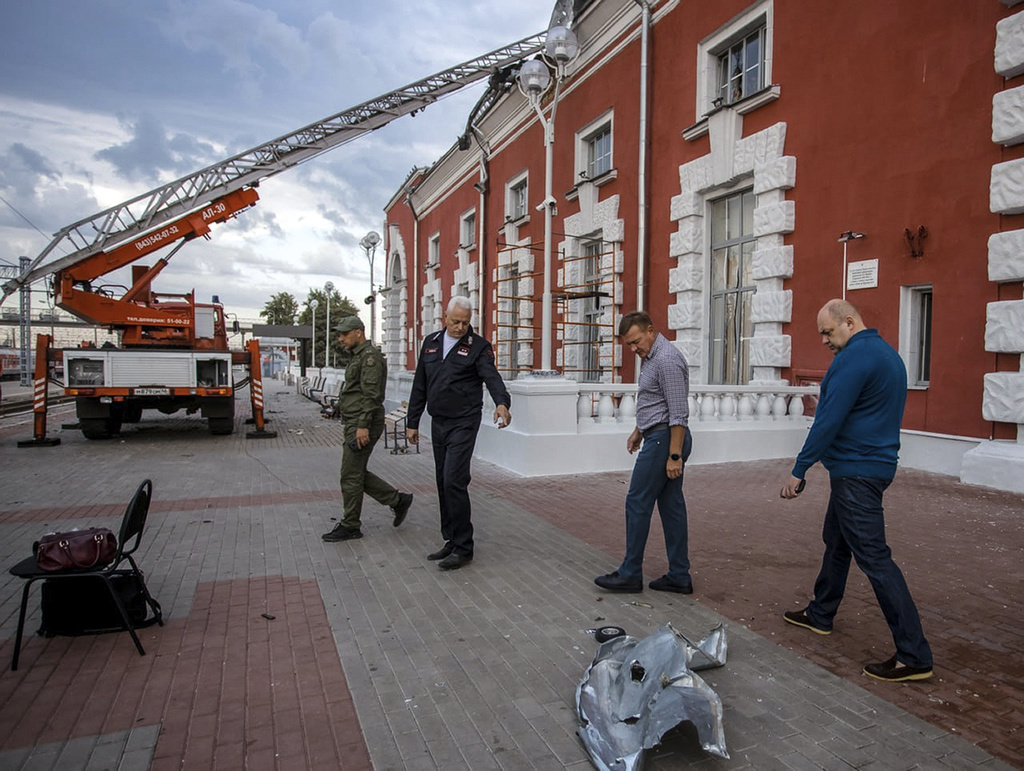 This photo released by governor of Kursk region Roman Starovoit telegram channel, on Sunday, Aug. 20, 2023, shows Roman Starovoit, governor of Kursk region, second right, and other officials inspect the site of a train station after an allegedly Ukrainian drone attack in Kursk, Russia. Five people were wounded when a reportedly Ukrainian drone hit a train station in the city of Kursk, regional Gov. Roman Starovoit said early Sunday. According to Starovoit, the drone crashed into the roof of the railway station building, with a fire subsequently breaking out on the roof. (Governor of Kursk region Roman Starovoit telegram channel via AP)