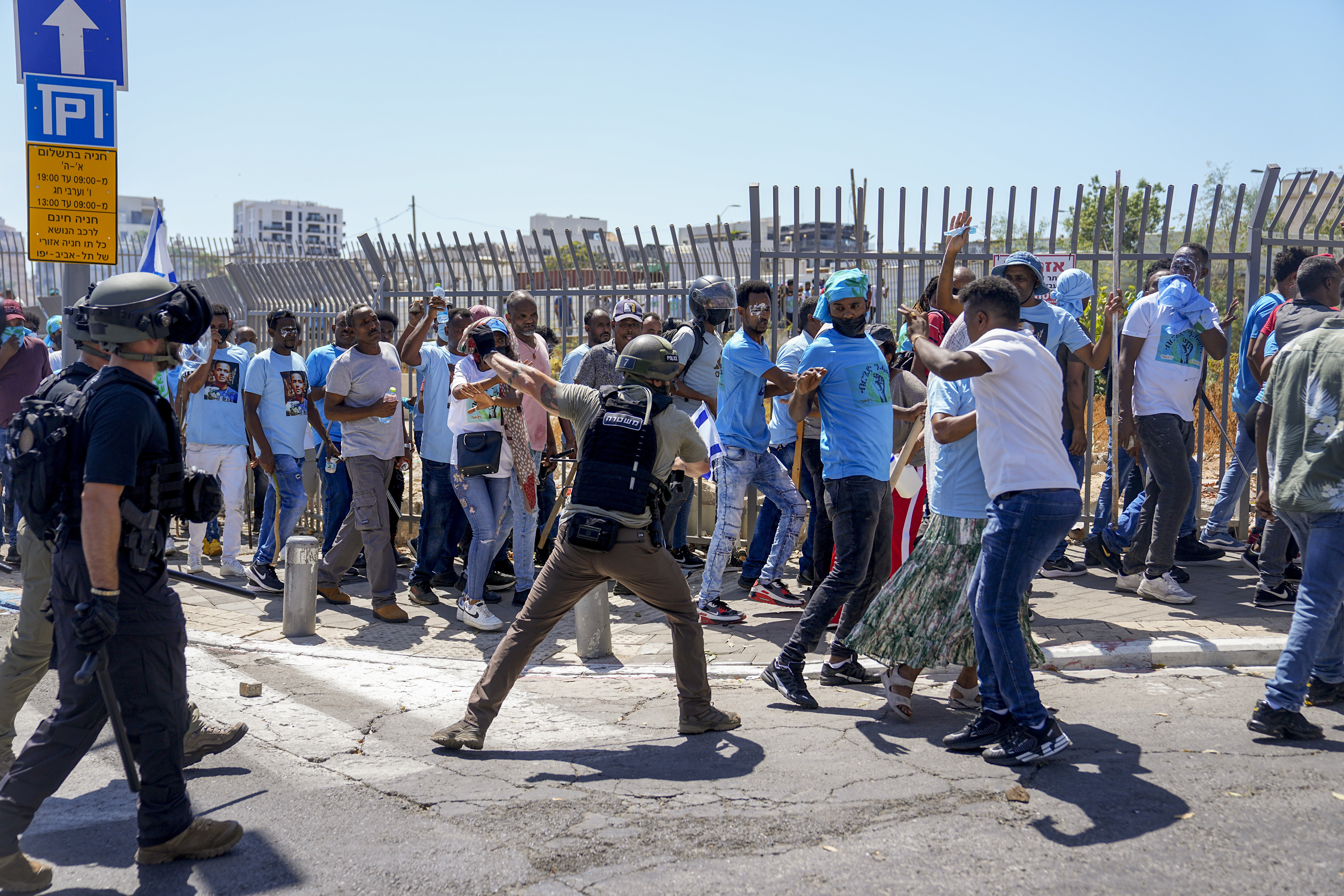 Eritrean protesters clash with Israeli riot police in Tel Aviv, Israel, Saturday, Sept. 2, 2023. Hundreds of Eritrean asylum seekers smashed shop windows and police cars in Tel Aviv on Saturday and clashed with police during a protest against an event organized by the Eritrea Embassy. The Israeli police said 27 officers were injured in the clashes, and at least three protesters were shot when police opened fire with live rounds when they felt "real danger to their lives." (AP Photo/Ohad Zwigenberg)