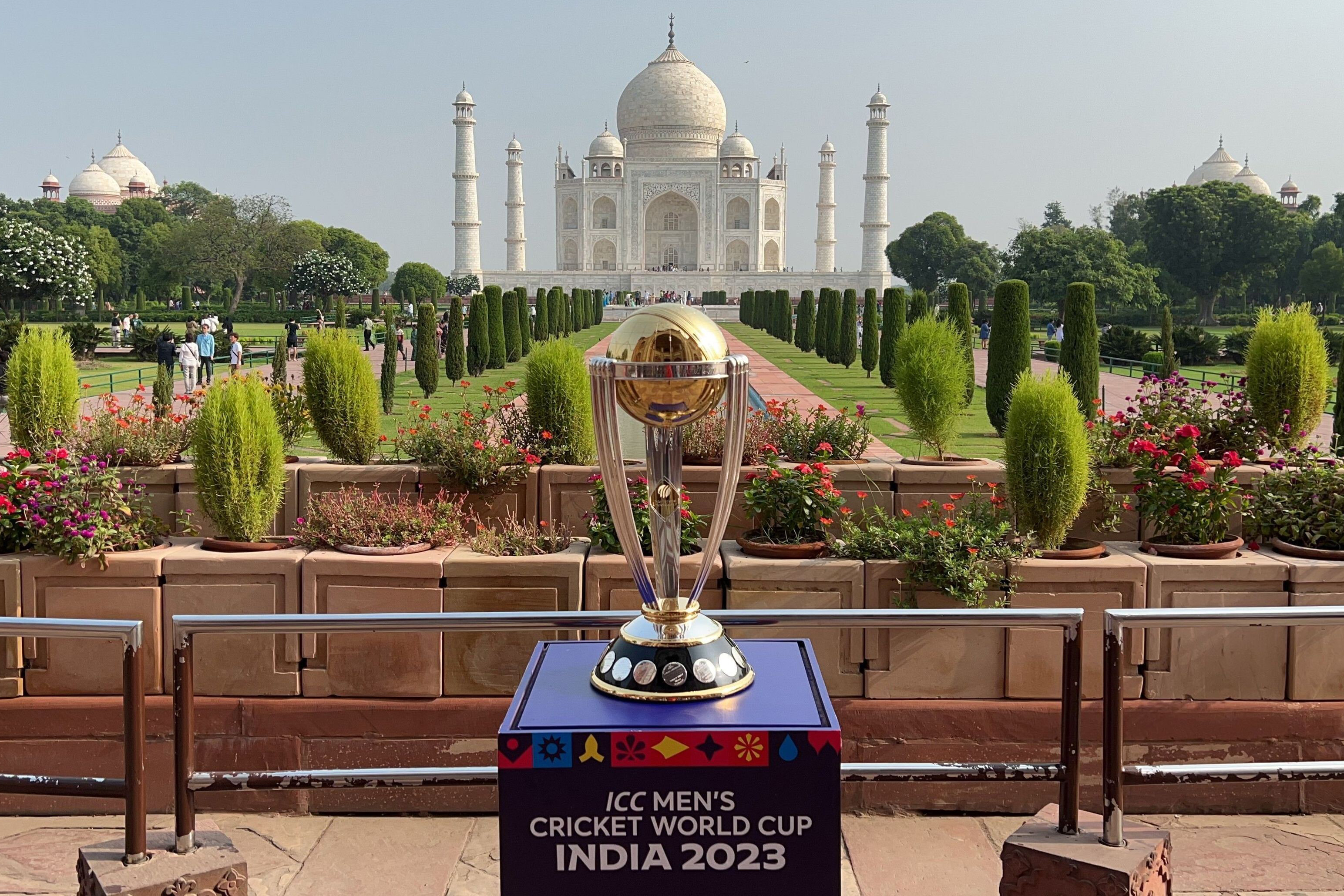 ICC world cup trophy against the backdrop of Agra. The Taj Mahal can be seen.