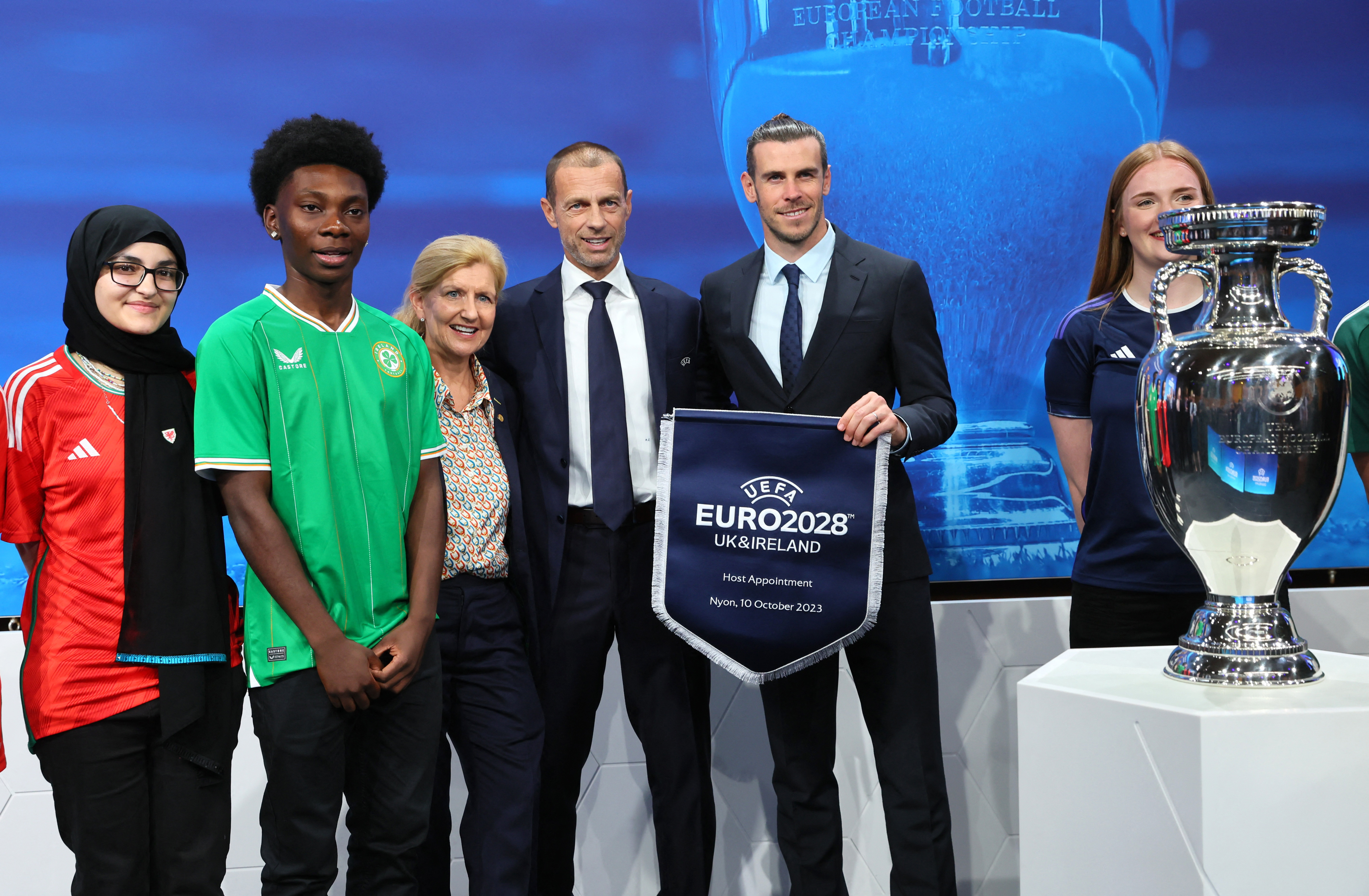 UEFA president Aleksander Ceferin and UK-Ireland ambassadors including Gareth Bale pose with the trophy after UK and Ireland are announced as the hosts for Euro 2028