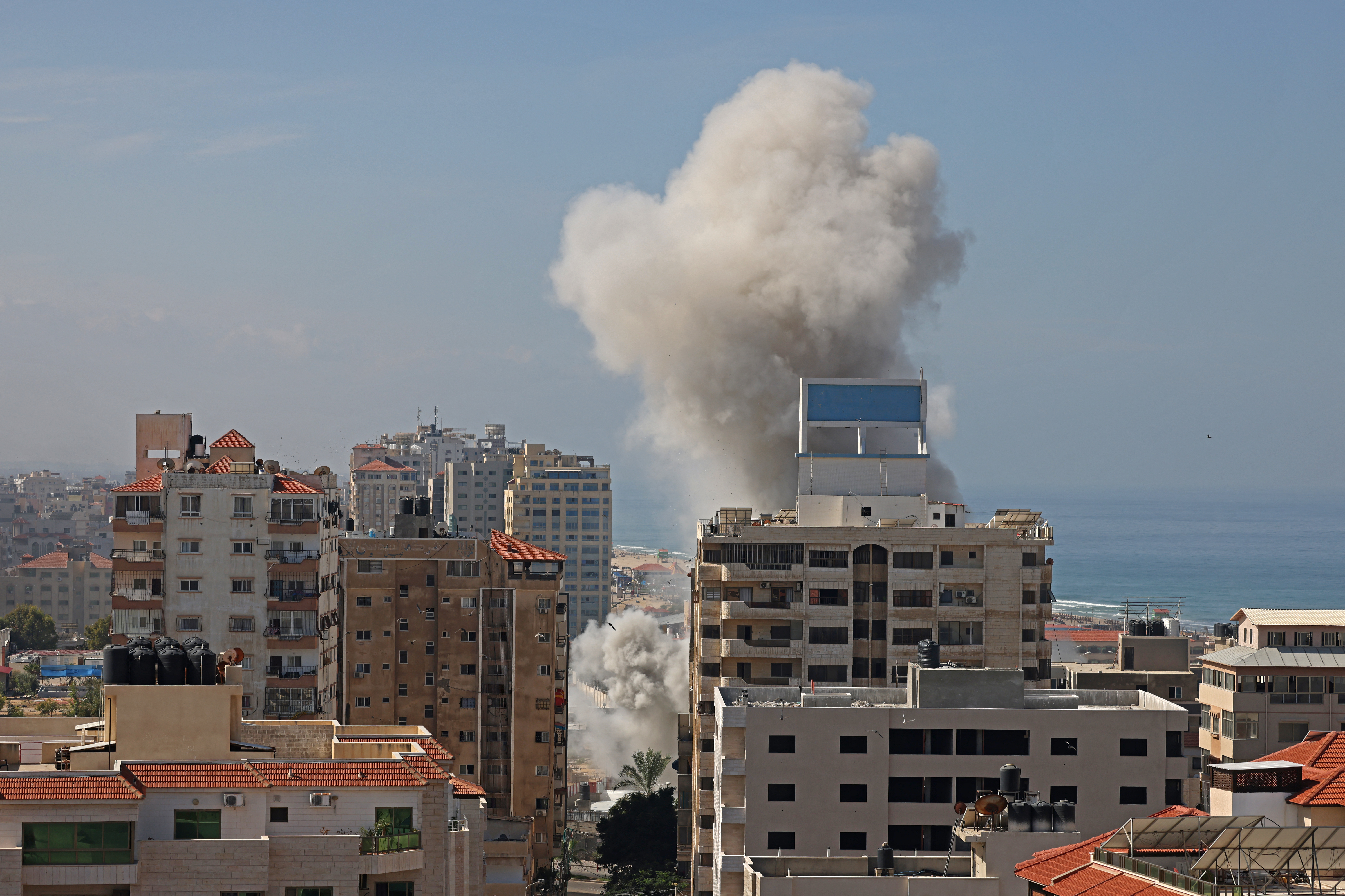 Smoke billows from a residential building following an Israeli airstrike in Gaza City