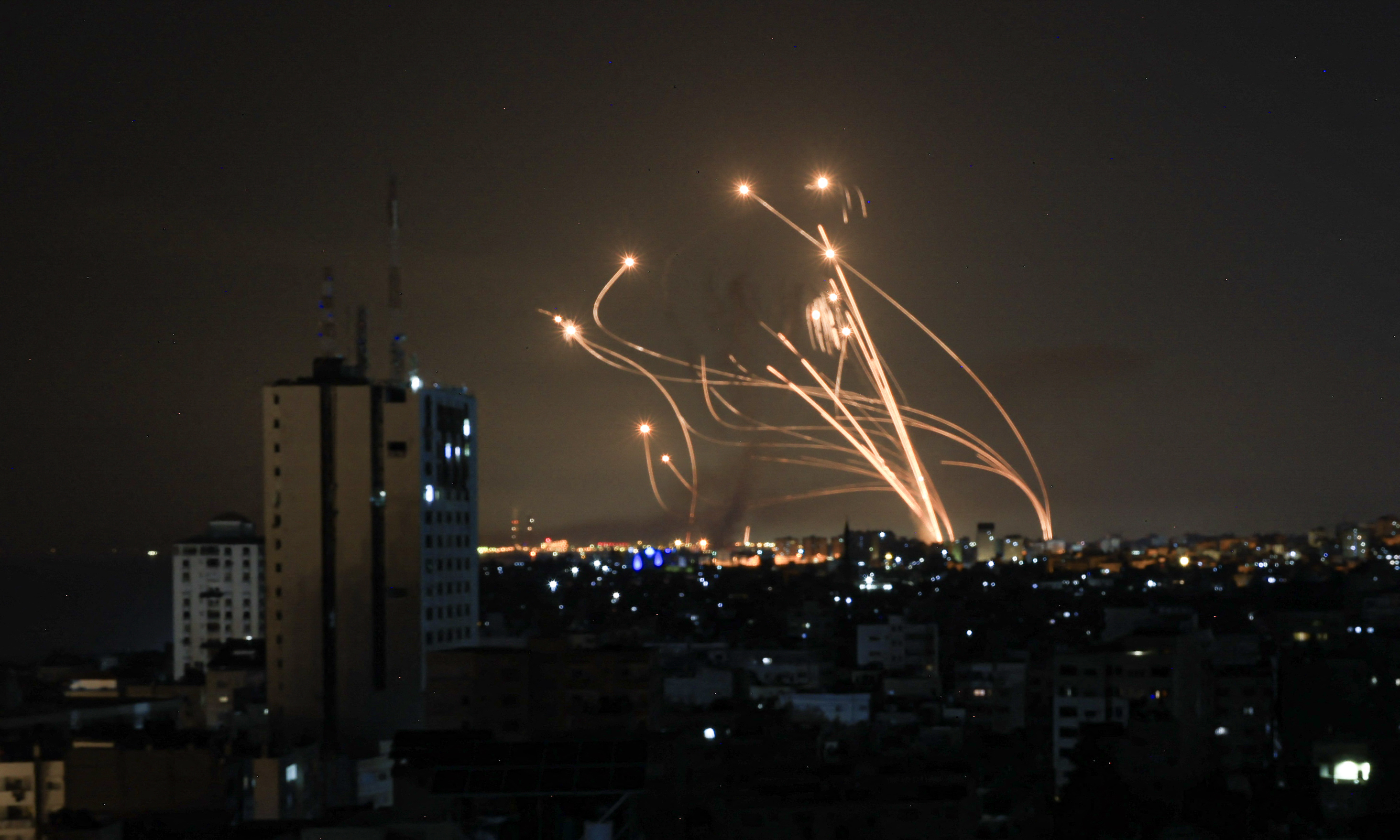 An Israeli missile launched from the Iron Dome defence missile system attempts to intercept a rocket, fired from the Gaza Strip, over the city of Netivot in southern Israel on October 8, 2023.