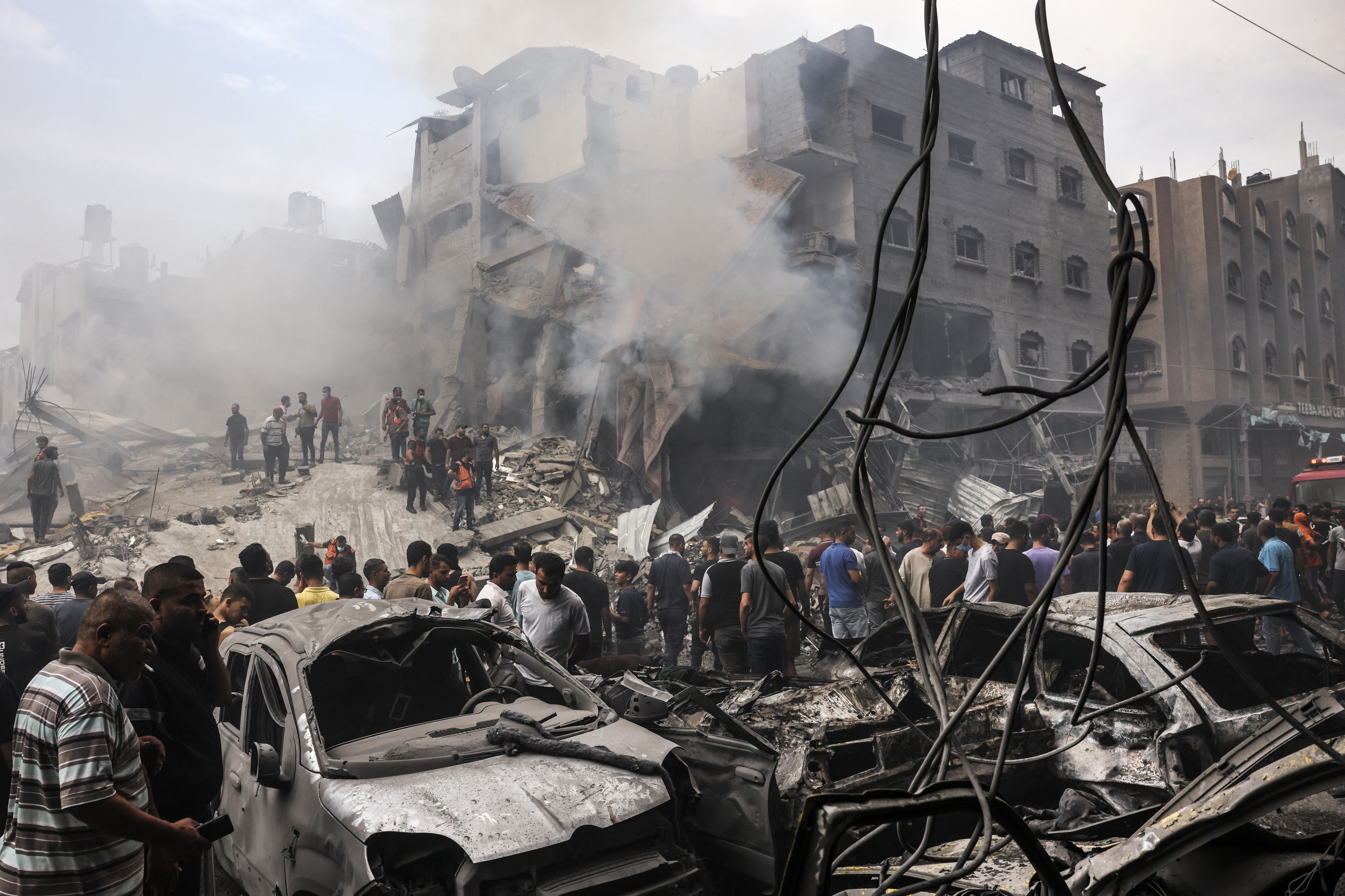Palestinians search for survivors after an Israeli airstrike on buildings in the refugee camp of Jabalia