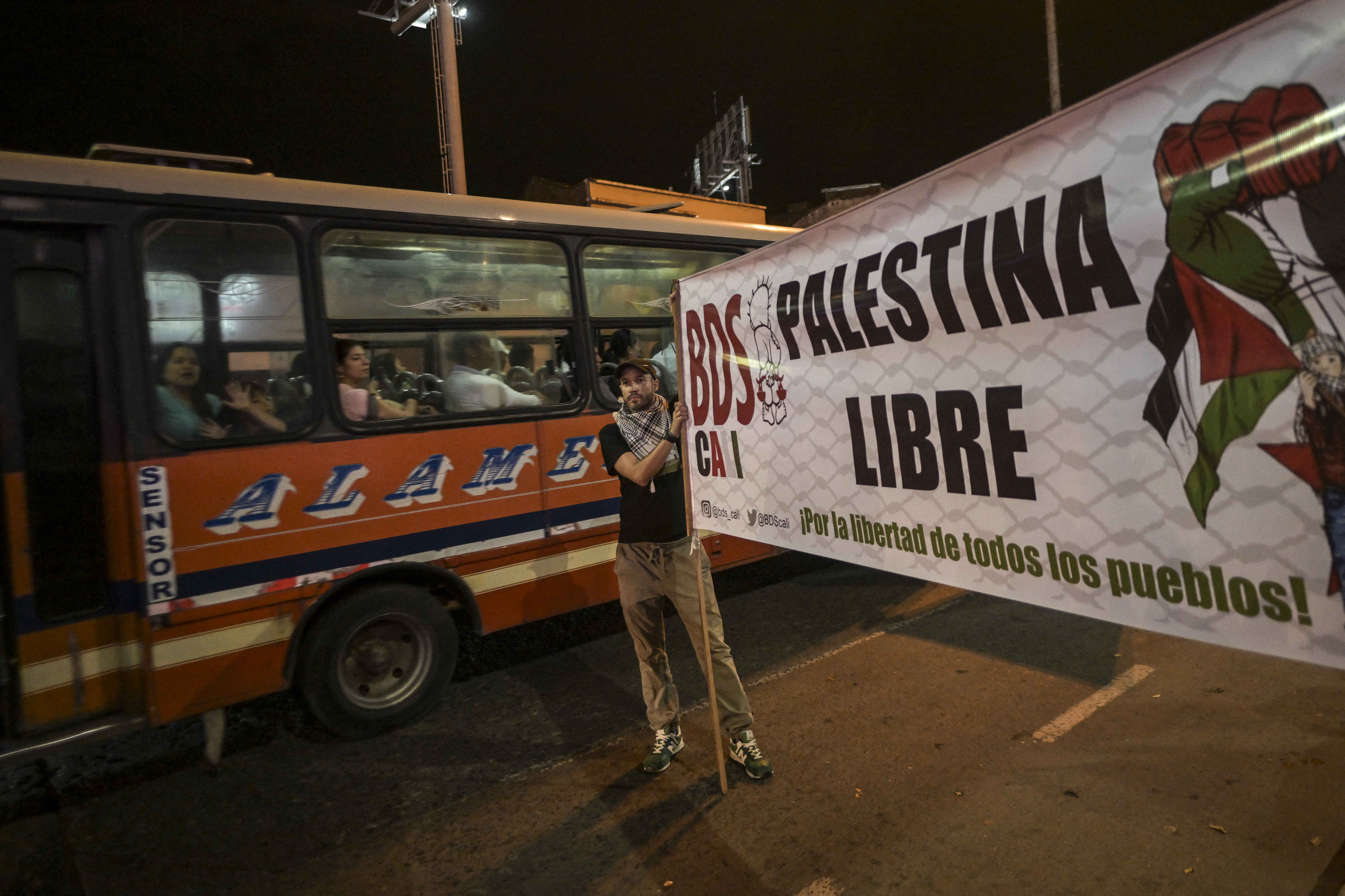 A man holds a sign reading "Free Palestine" during a demonstration in support of Palestinians in Cali, Colombia