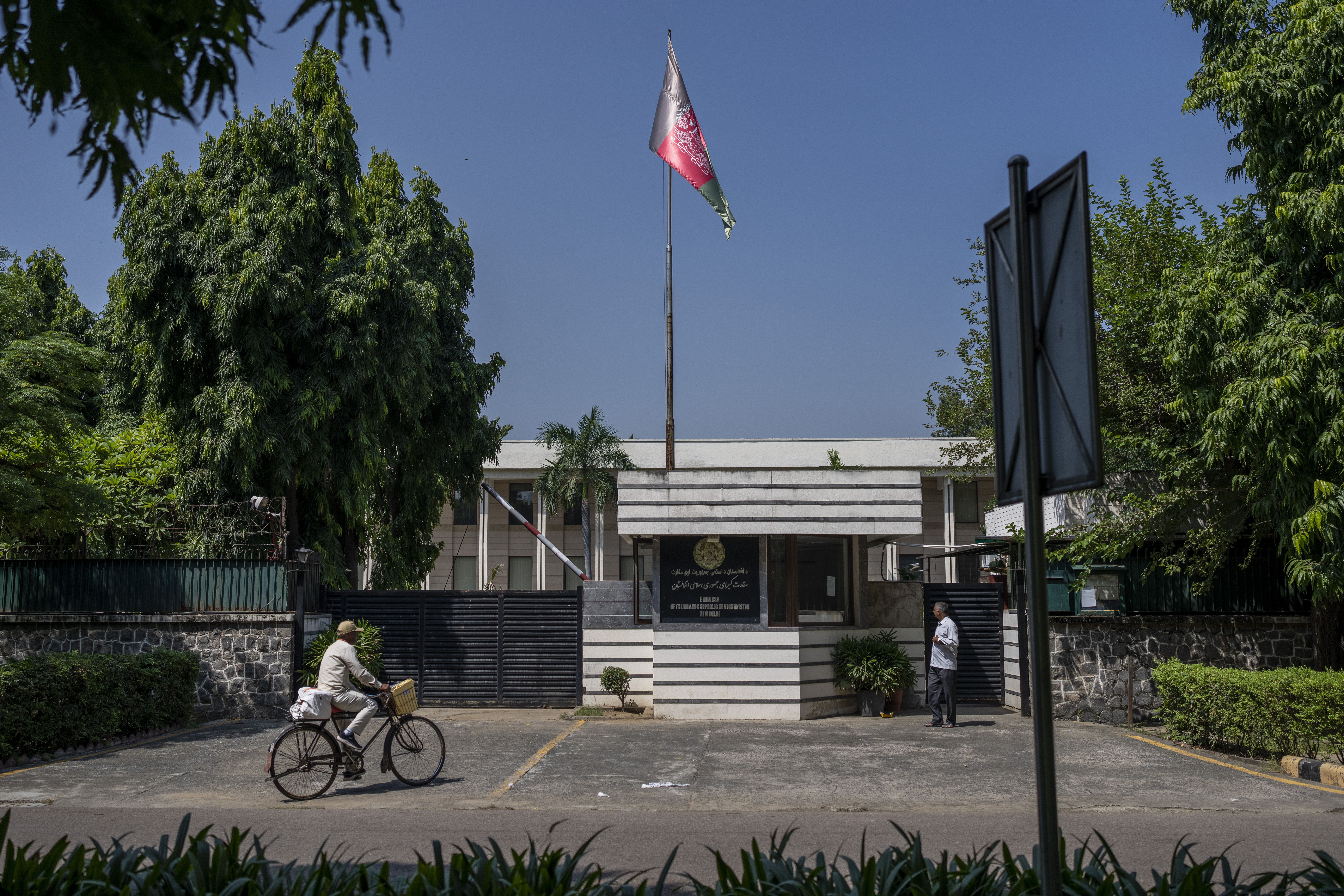 A cyclist pedals past the Afghan Embassy in New Delhi