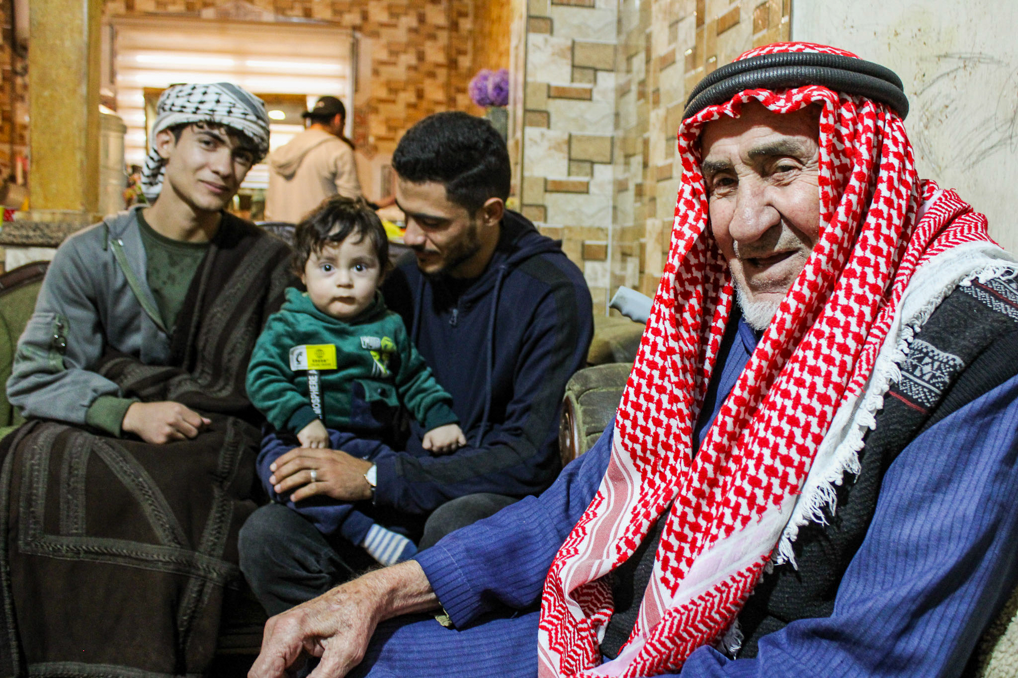 Mohammad Nashwan (left wearing keffiyeh), baby Tayem, Tayem&#039;s father and Saadi&#039;s son, Souhayb, and Abdullah [Hanna Davis/Al Jazeera]