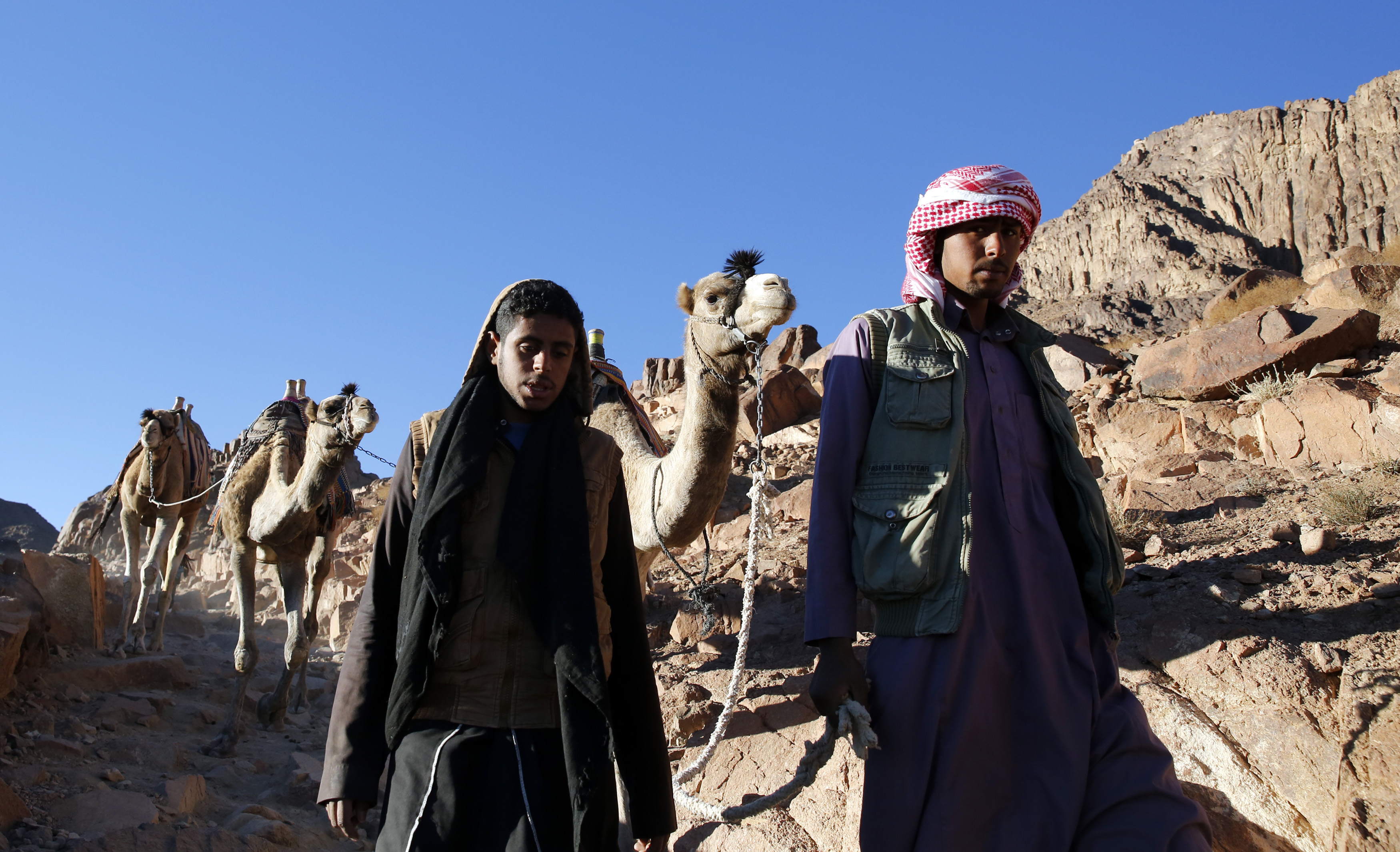 Bedouin mountain guides make their way down from the summit of Mount Moses, near the city of Saint Catherine, in the Sinai Peninsula, south of Egypt, December 9, 2015. According to the Bible, the mountain is where Moses received the ten commandments from God. Picture taken December 9, 2015. REUTERS/Amr Abdallah Dalsh