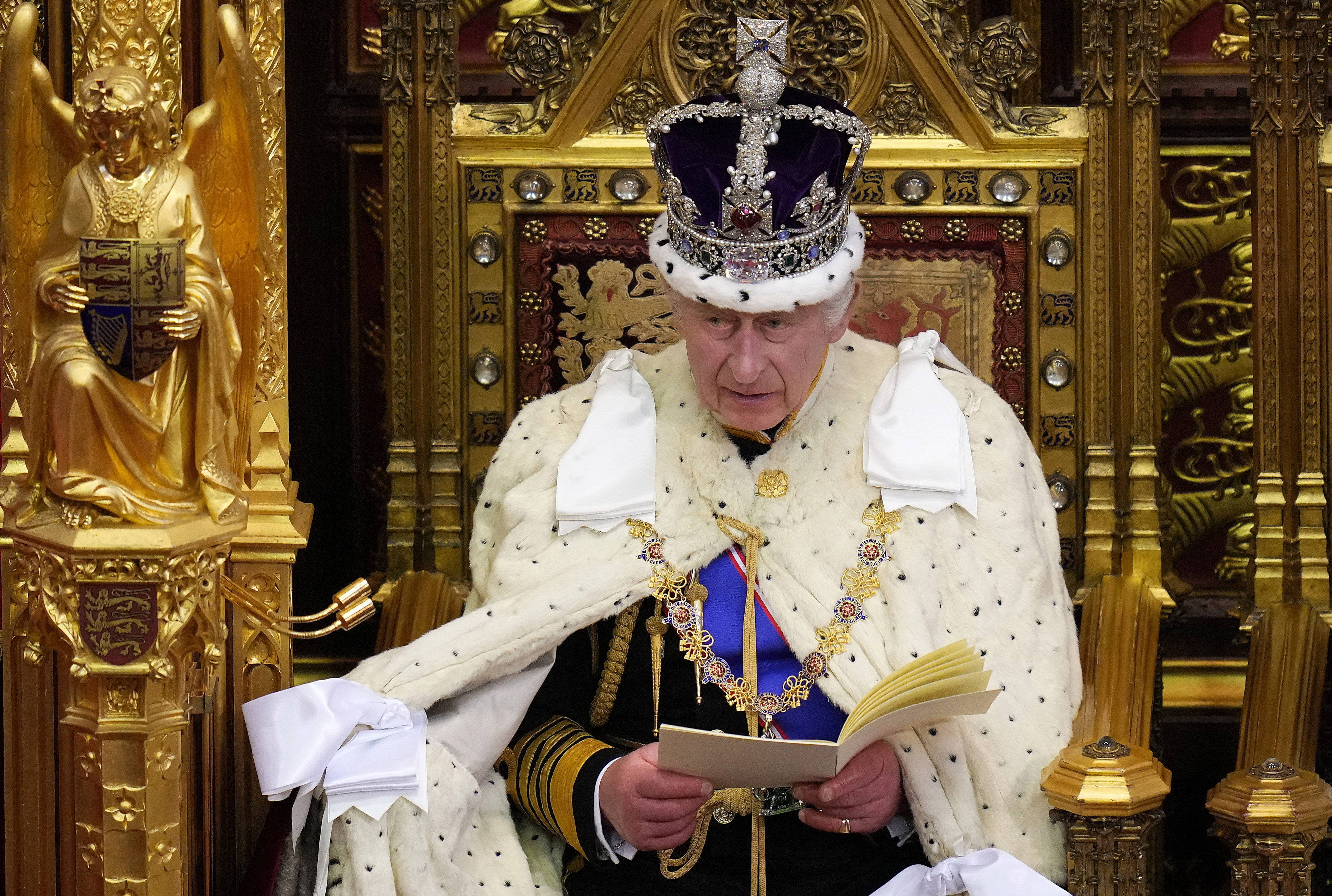 Britain's King Charles III, wearing the Imperial State Crown and the Robe of State, reads the King's speech from The Sovereign's Throne in the House of Lords chamber, during the State Opening of Parliament, at the Houses of Parliament, in London, on November 7, 2023. (Photo by Kirsty Wigglesworth / POOL / AFP)