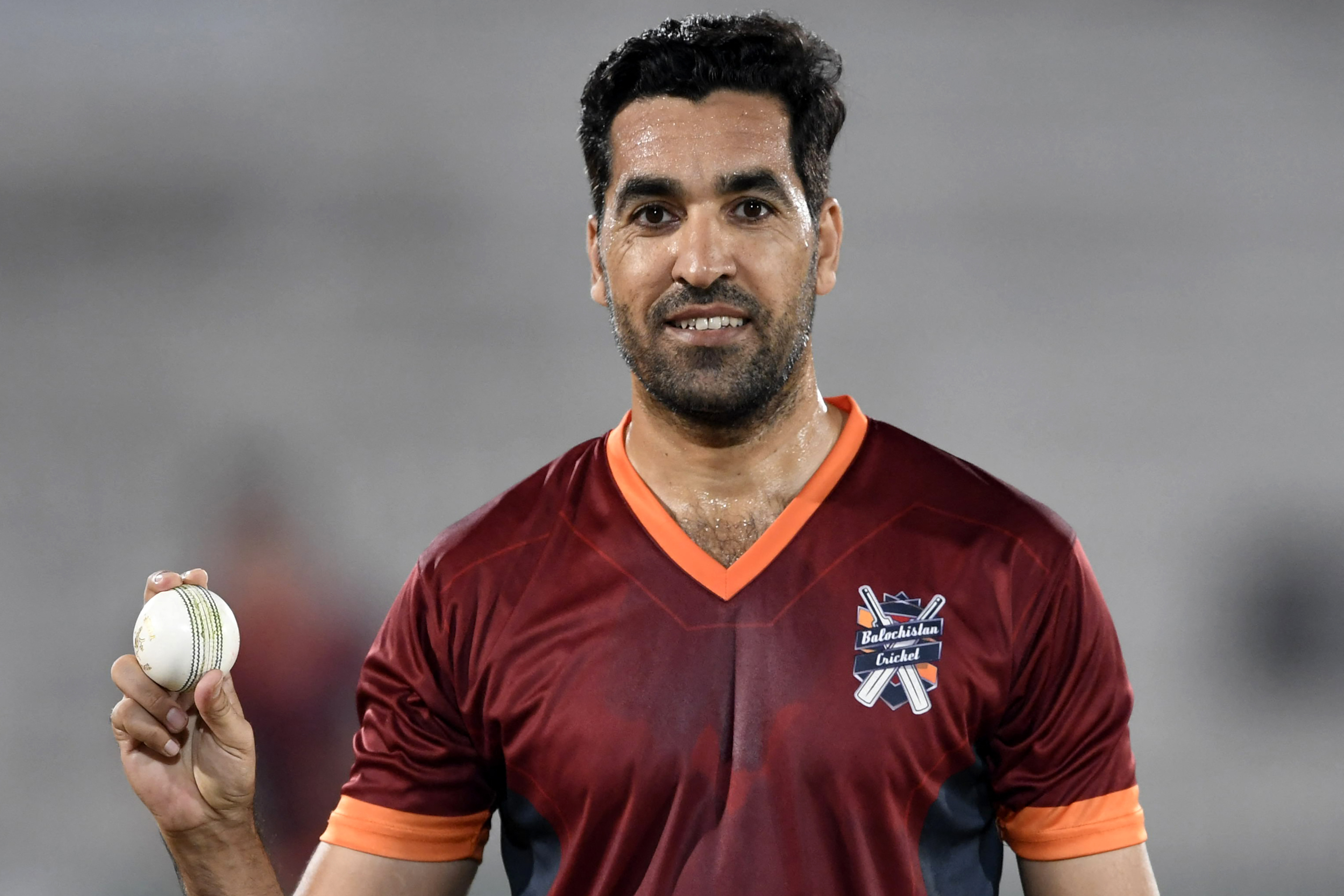 Pakistani cricketer Umar Gul holds a ball