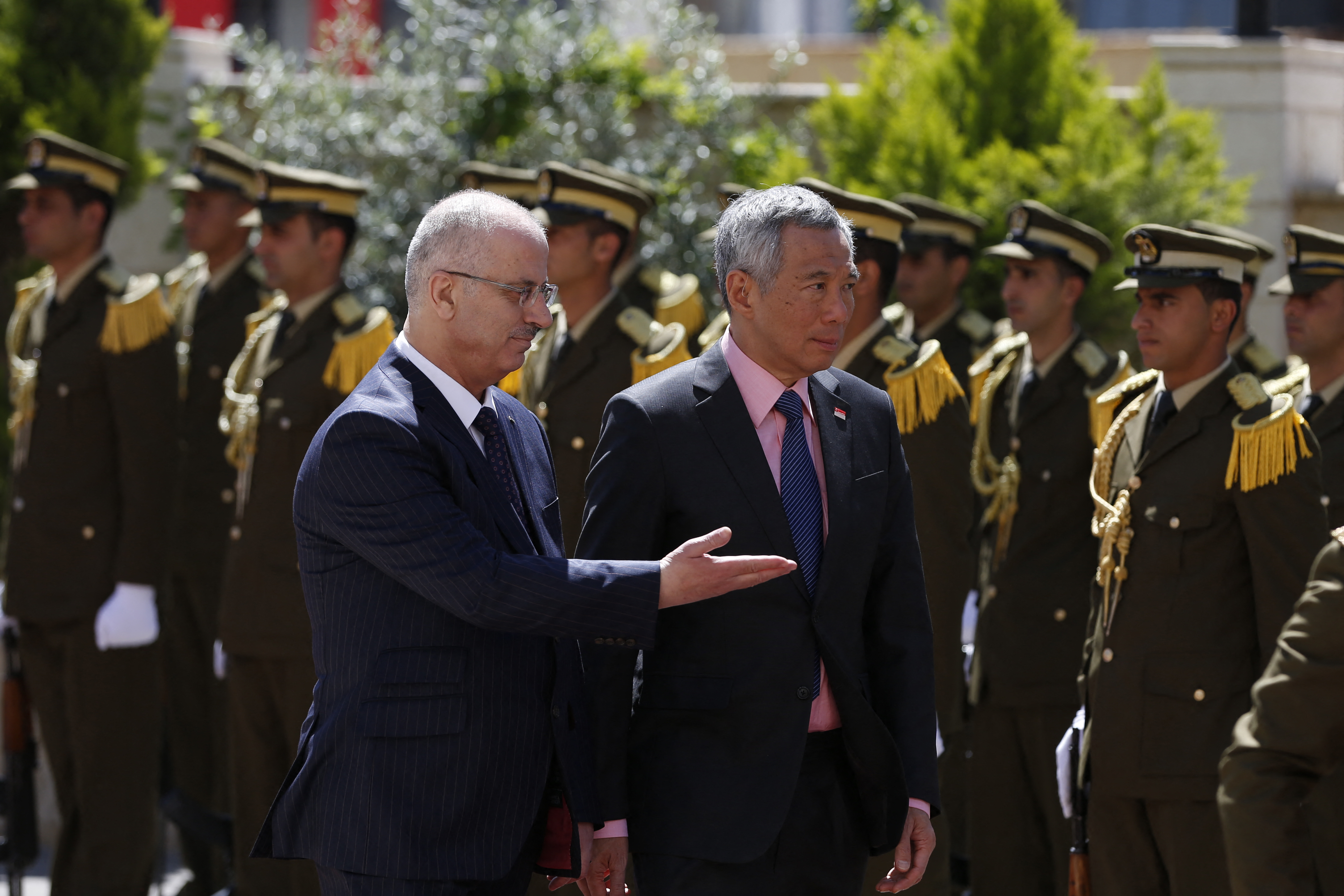 Singapore's Prime Minister on a visit to Ramallah in 2016. He is inspecting an honour guard accompanied by the then Palestinian prime minister Rami Hamdallah