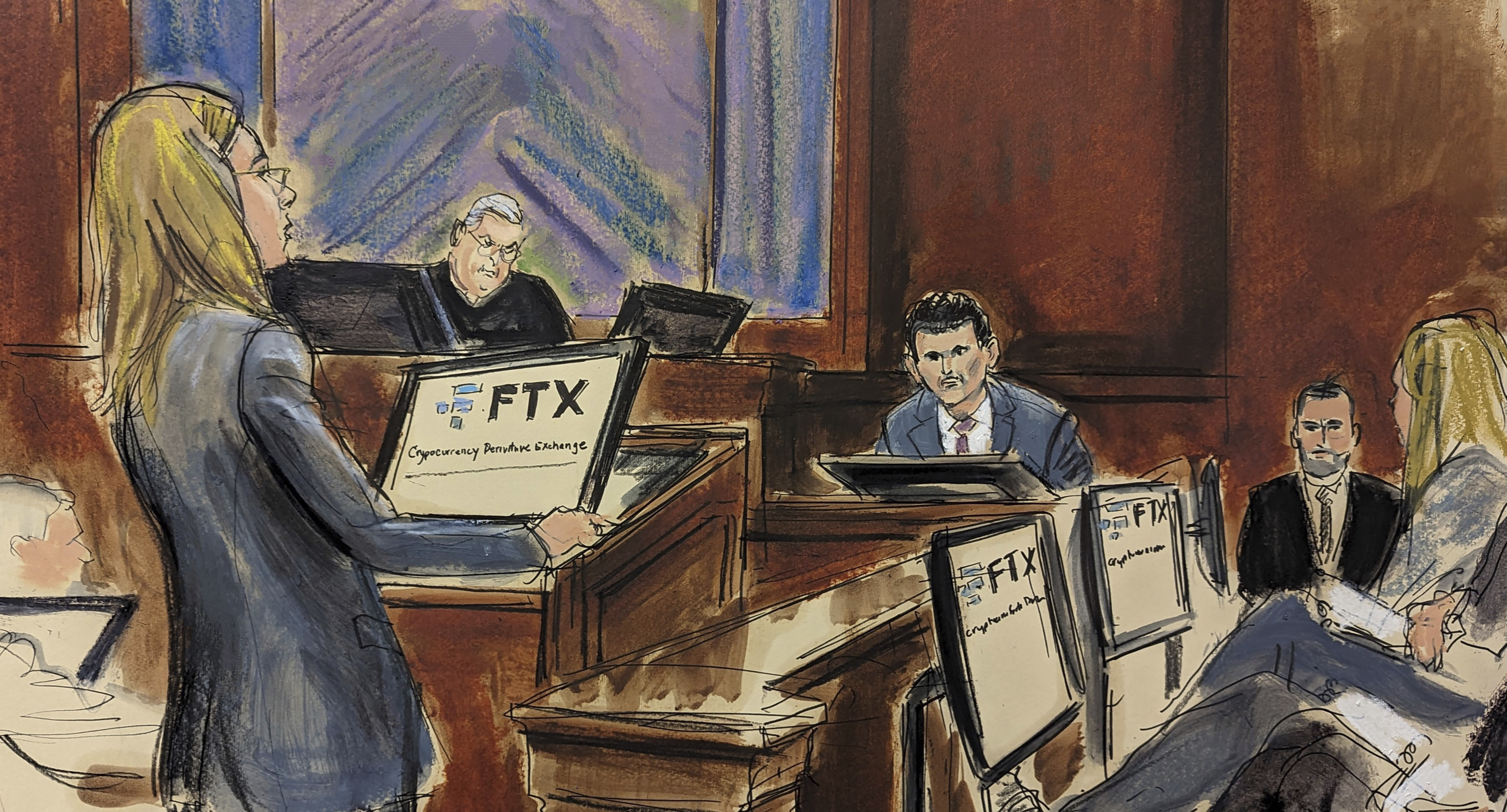 In this courtroom sketch, FTX founder Sam Bankman-Fried, background center, is cross examined by U.S. Assistant Attorney Danielle Sassoon, left, while Judge Lewis Kaplan listens, background second left, in Manhattan federal court, Monday, Oct. 30, 2023, in New York. Members of the jury are seated at right.