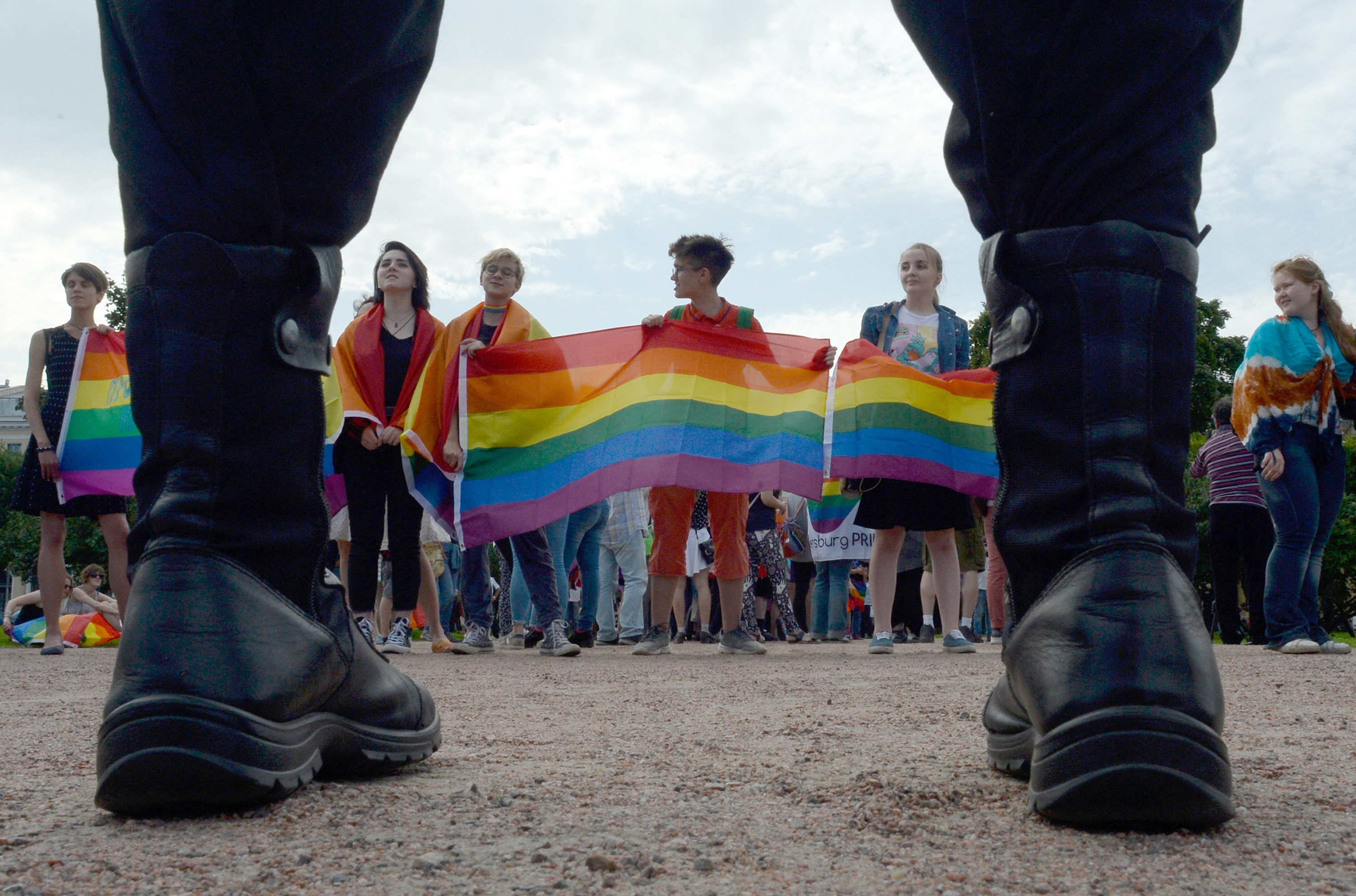 A picture taken on August 12, 2017 shows people waving gay rights' movement rainbow flags during the gay pride rally in Saint-Petersburg. [OLGA MALTSEVA / AFP]