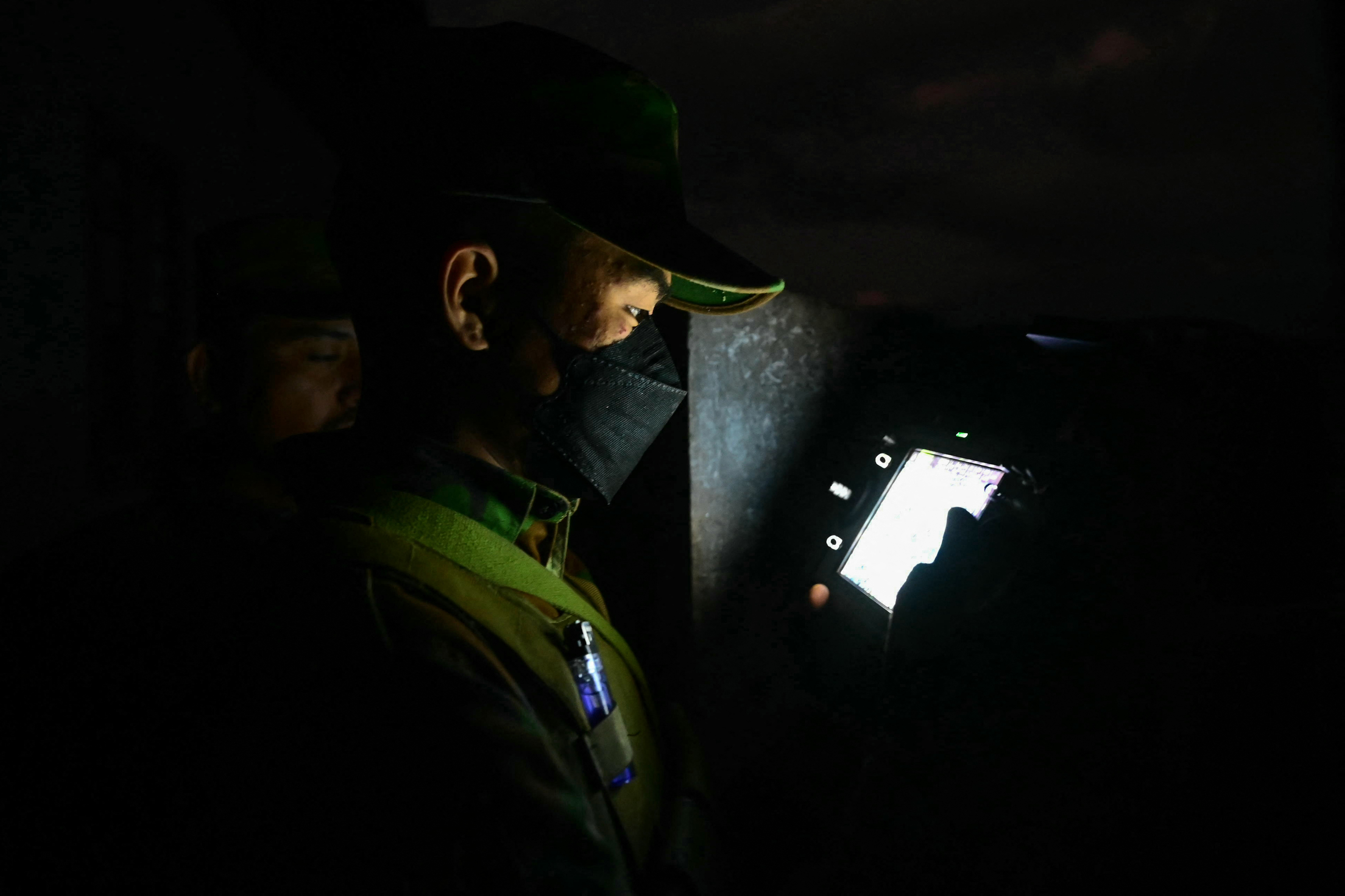 This photo taken on December 12, 2023 shows a member of ethnic minority armed group Ta'ang National Liberation Army (TNLA) controlling a drone during their attack on Myanmars military camp in Namhsan Township in Myanmar's northern Shan State.