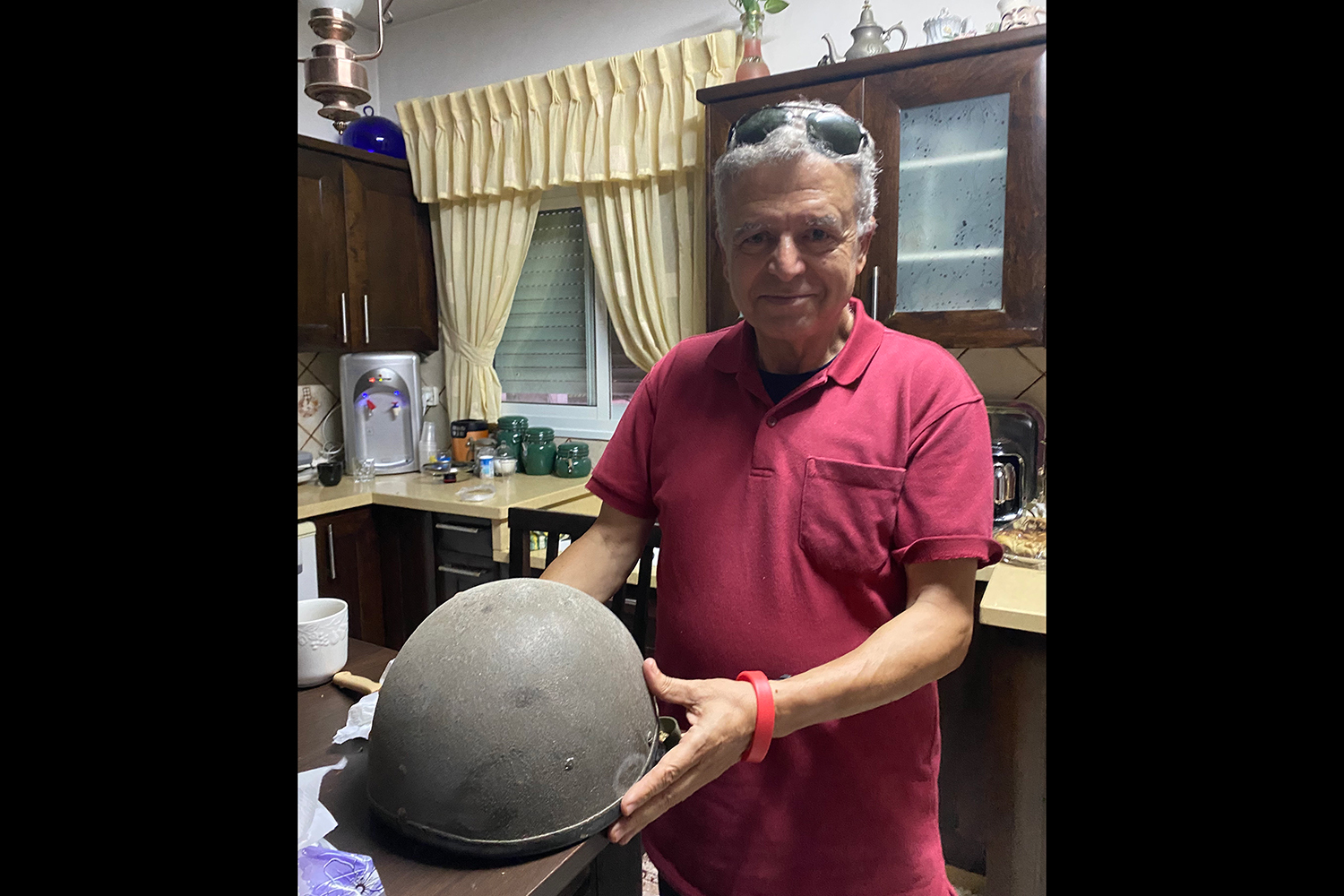 Said al-Ghazali holds the helmet he wore on assignment with Anthony Shadid when he was shot in Ramallah during the Second Intifada. September, 2023.