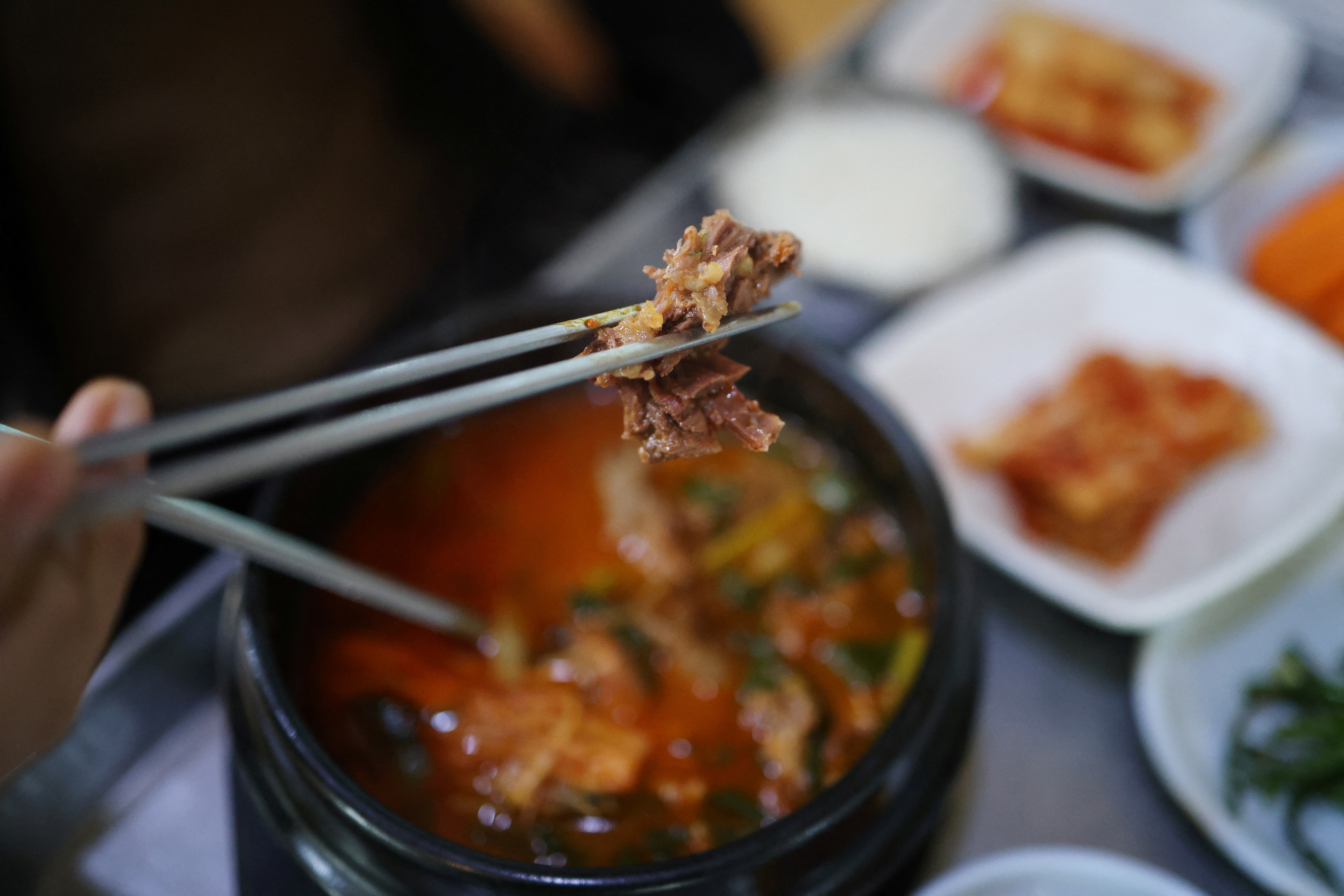 Yang Man-suk eats a dog meat broth or "Bosintang" at a restaurant in Hwaseong