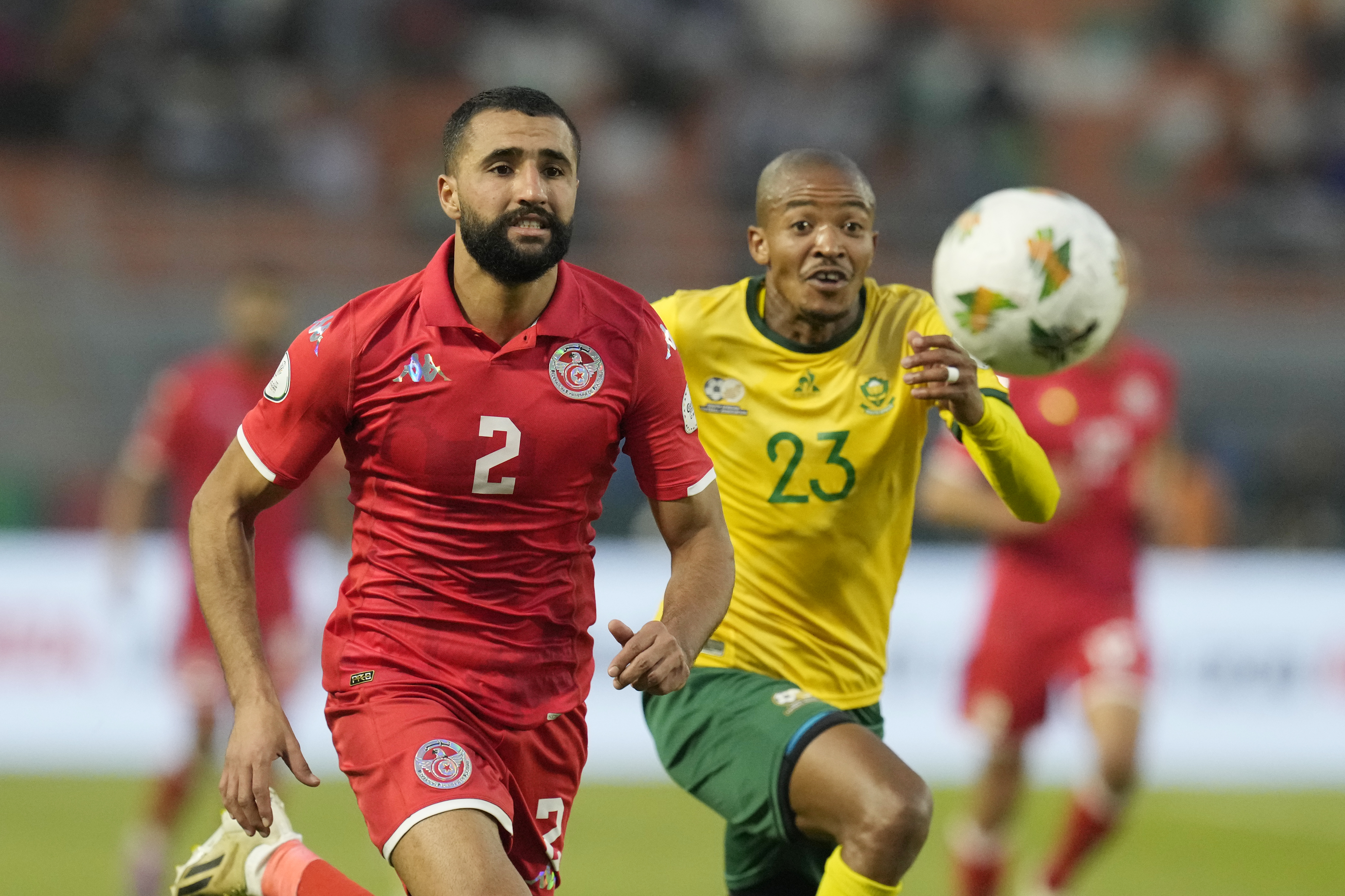 Tunisia's Ali Abdi, left, views for the ball with South Africa's Thapelo Morena