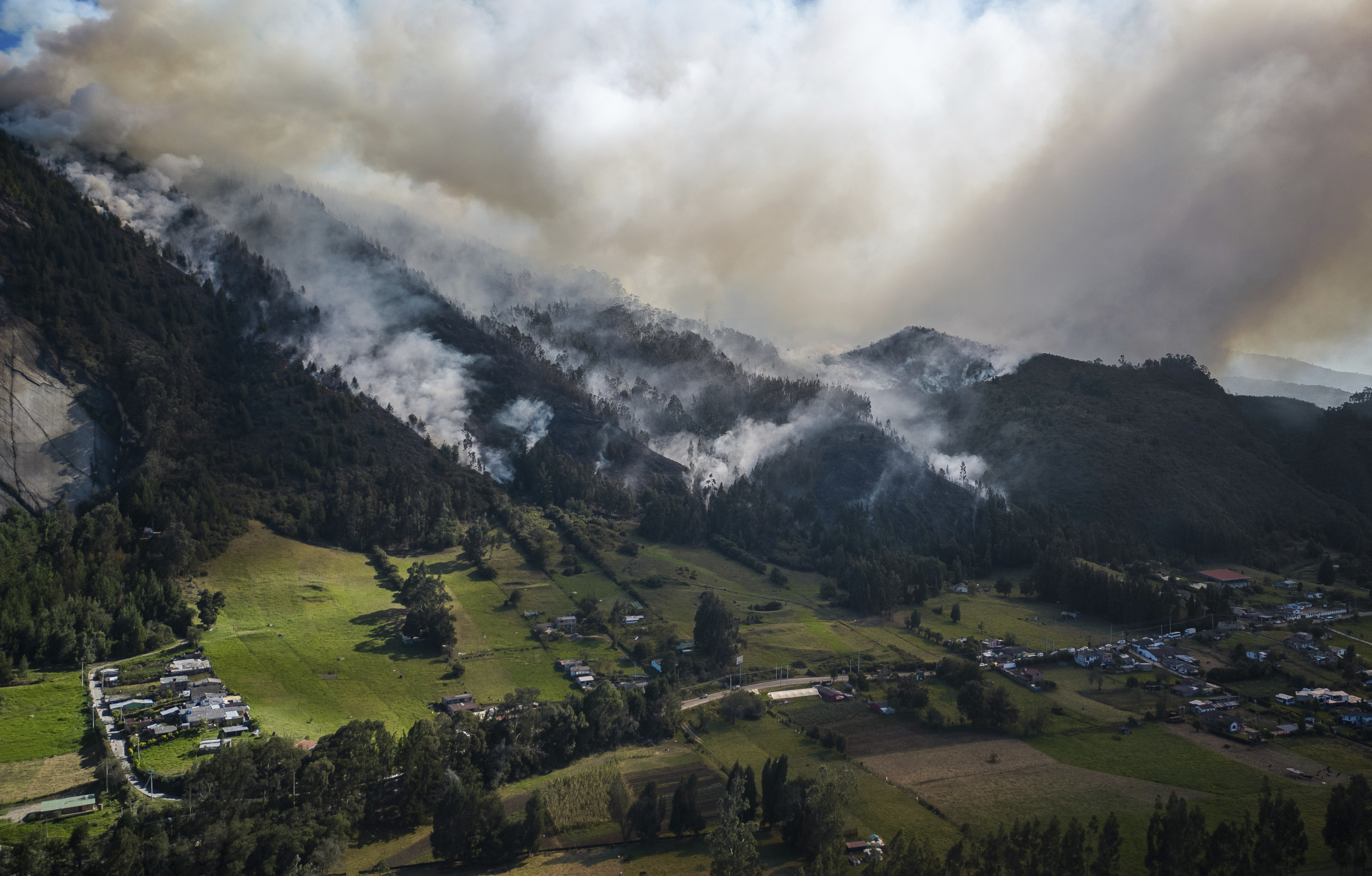 Smoke rises from a fire burning on the slopes of the mountains surrounding Nemocon, north of Bogota