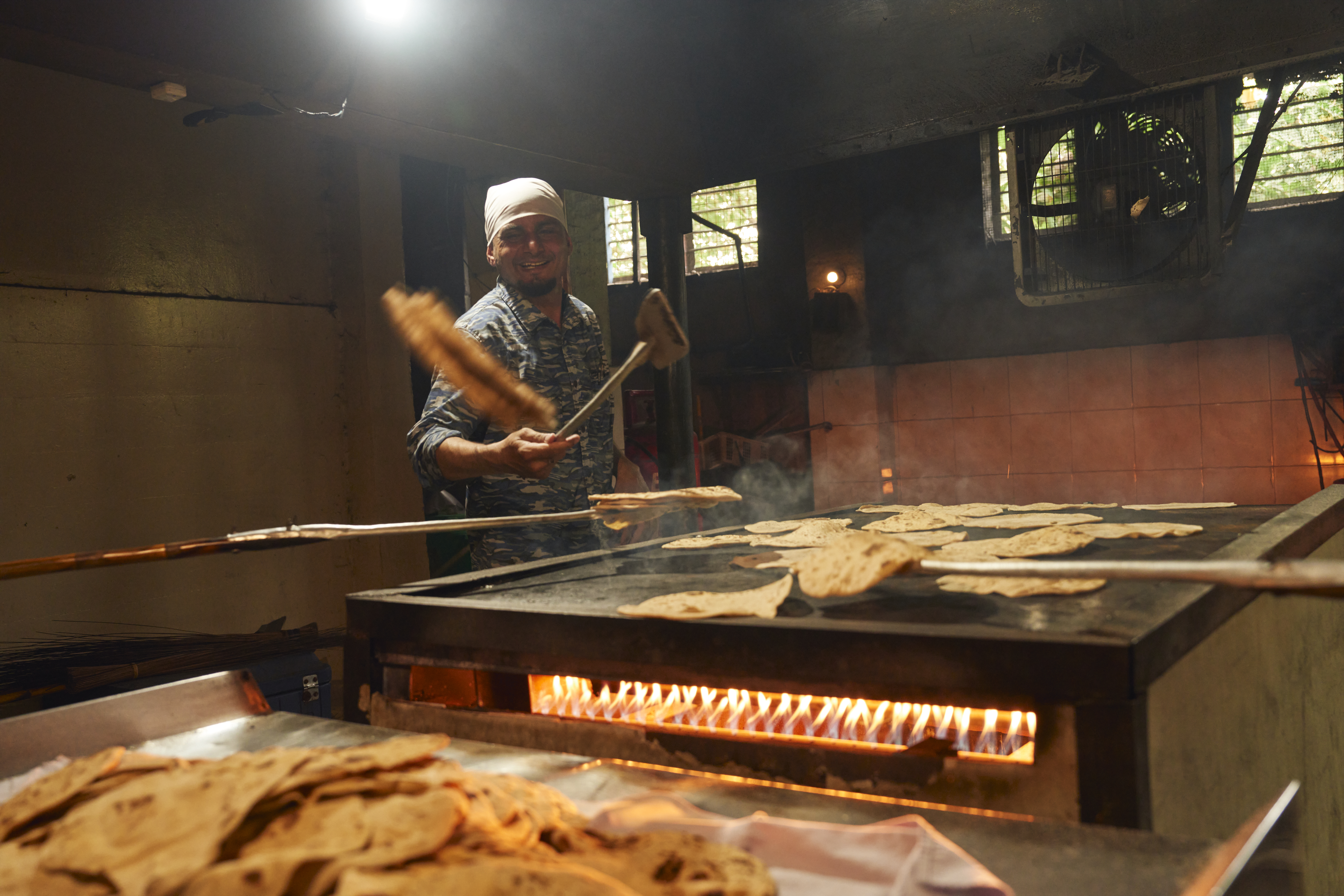 Volunteers at the Khalsa Diwan Sikh Temple Manila gather after lunch to prepare chapatis for the evening crowd