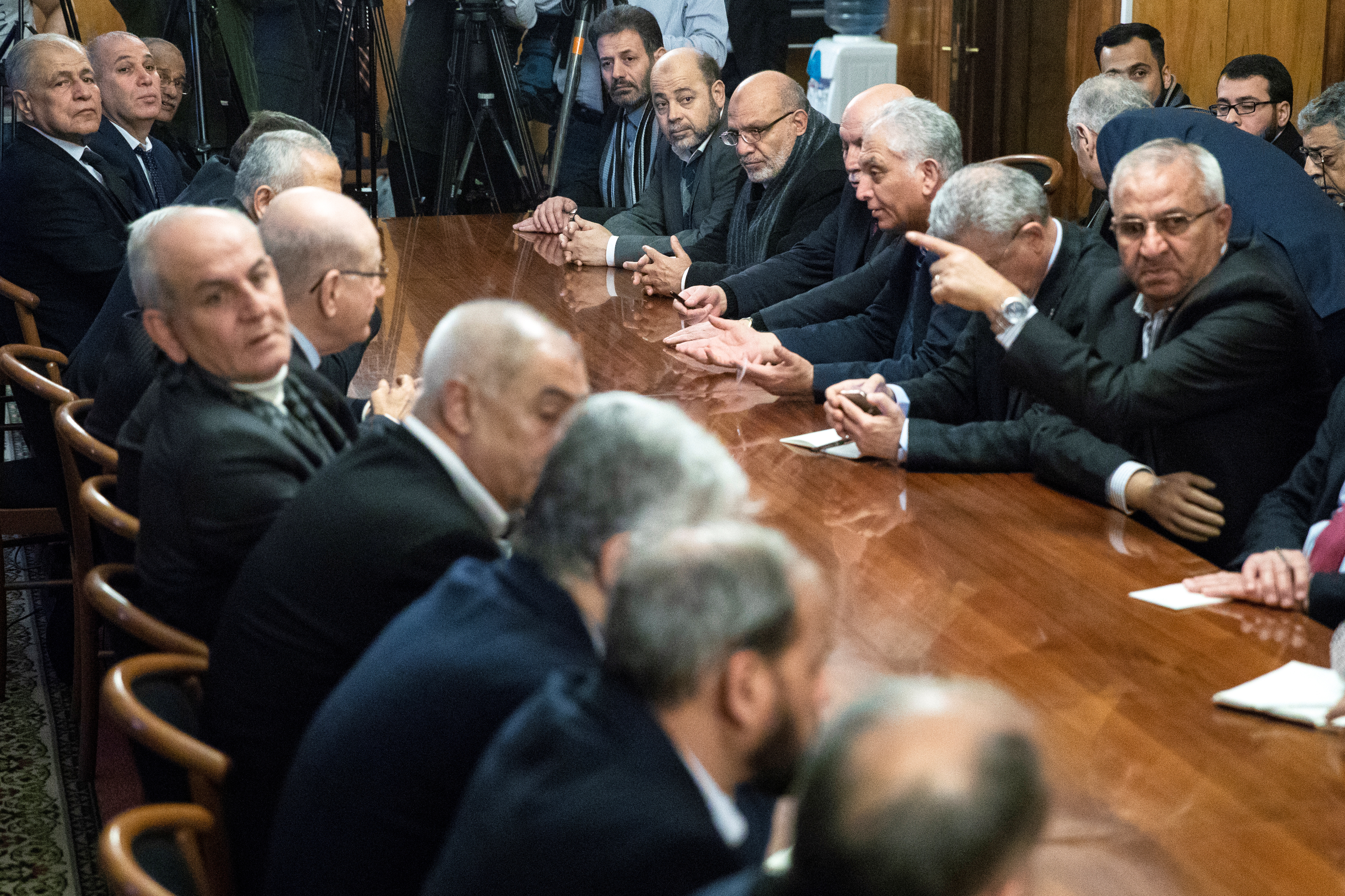 Fatah and Hamas officials wait for a meeting with Russian Foreign Minister Sergey Lavrov and representatives of Palestinian groups as a part of intra-Palestinian talks in Moscow on February 12, 2019 [Pavel Golovkin/Pool via Reuters]