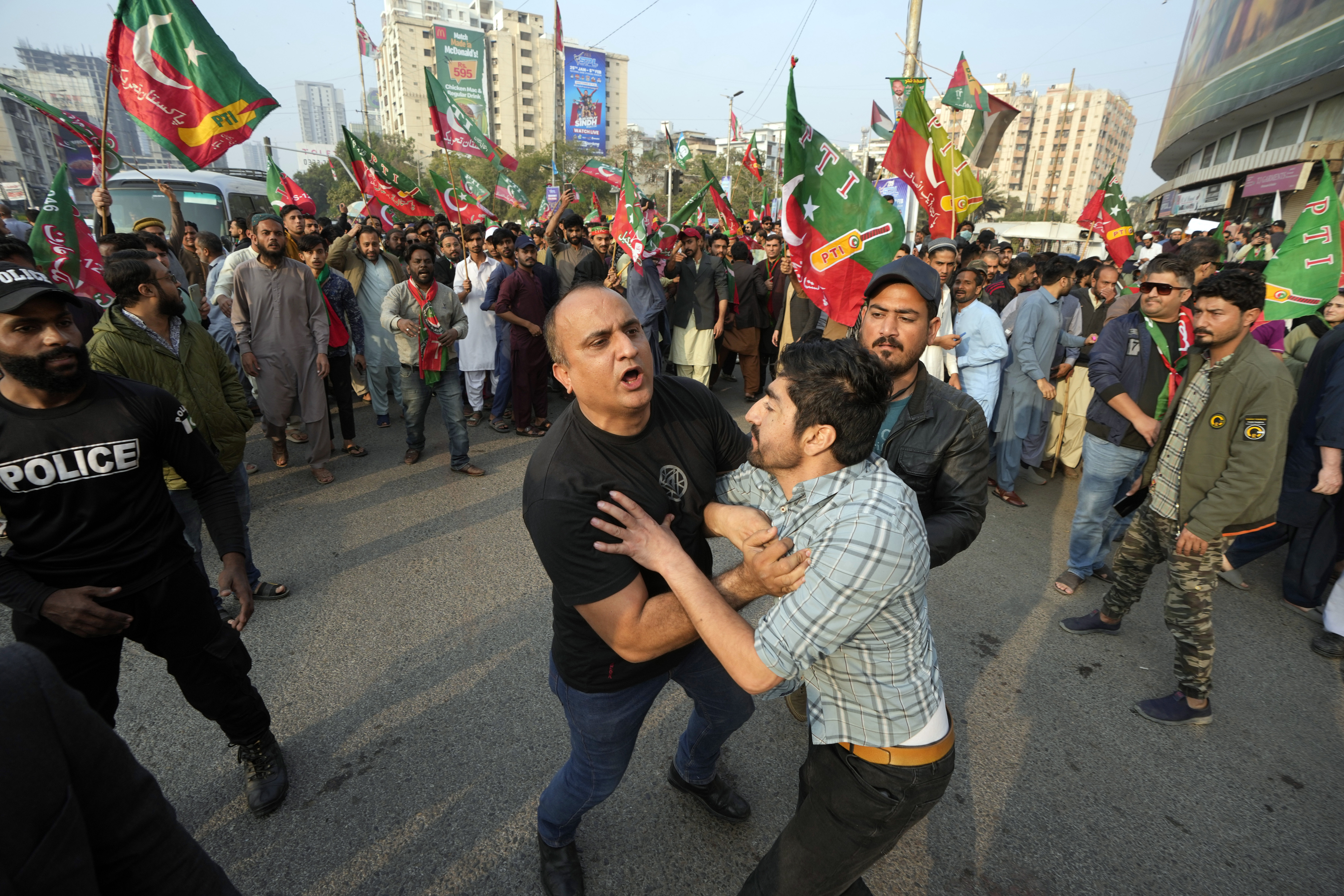 Pakistani Police detain supporter of former prime minister Imran Khan and political party Pakistan Tehreek-e-Insaf (PTI) during an election campaign rally in Karachi, Pakistan, Sunday, Jan. 28, 2024. Pakistani police fired tear gas to disperse supporters of former Prime Minister Imran Khan in the southern city of Karachi on Sunday, less than two weeks before a national parliamentary election that Khan was blocked from running in because of a criminal conviction. (AP Photo/Fareed Khan)