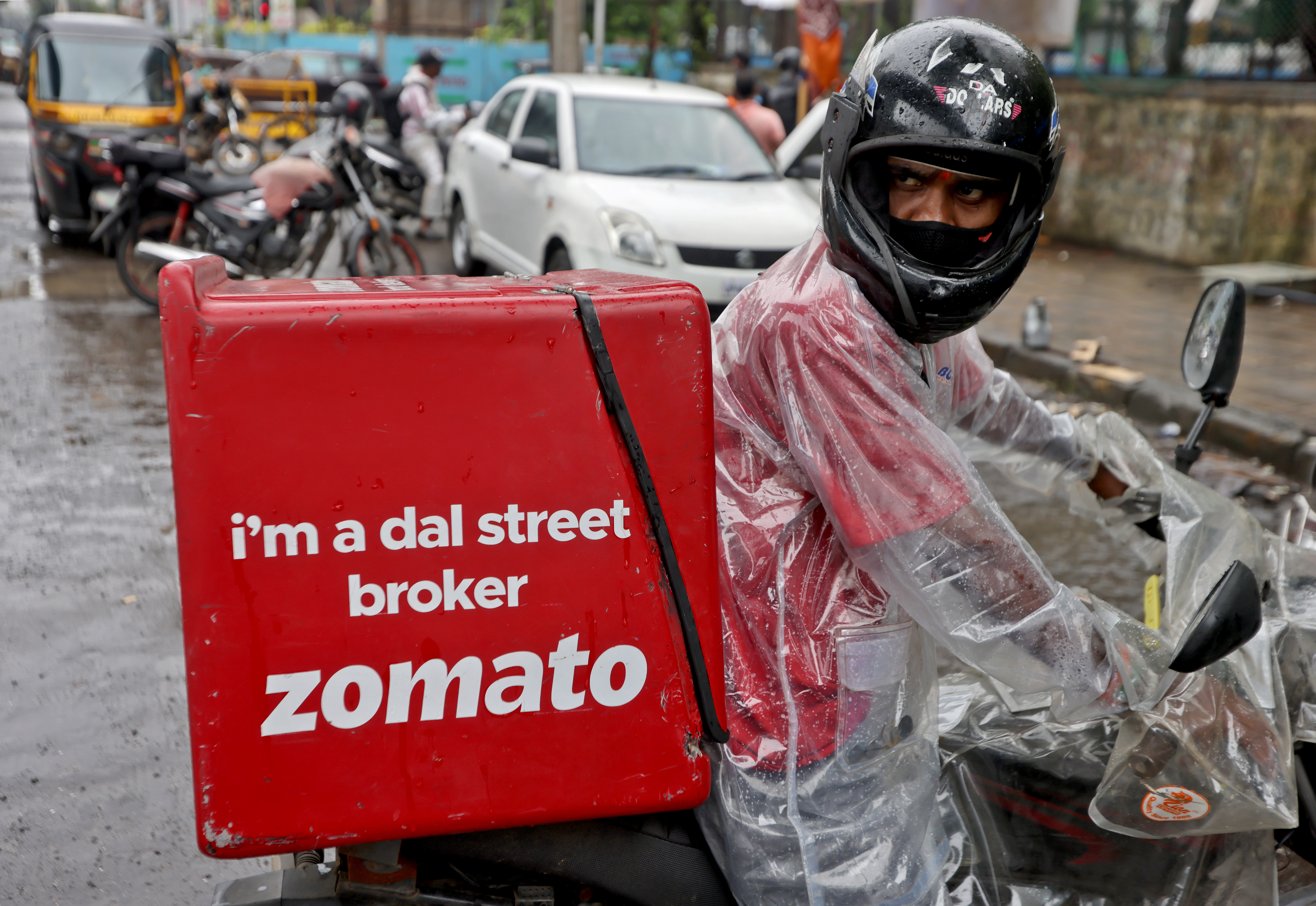 A delivery driver for Zomato, the food-delivery group, prepares to pick up an order from a restaurant in Mumbai, India, July 13, 2021 [Francis Mascarenhas/Reuters]