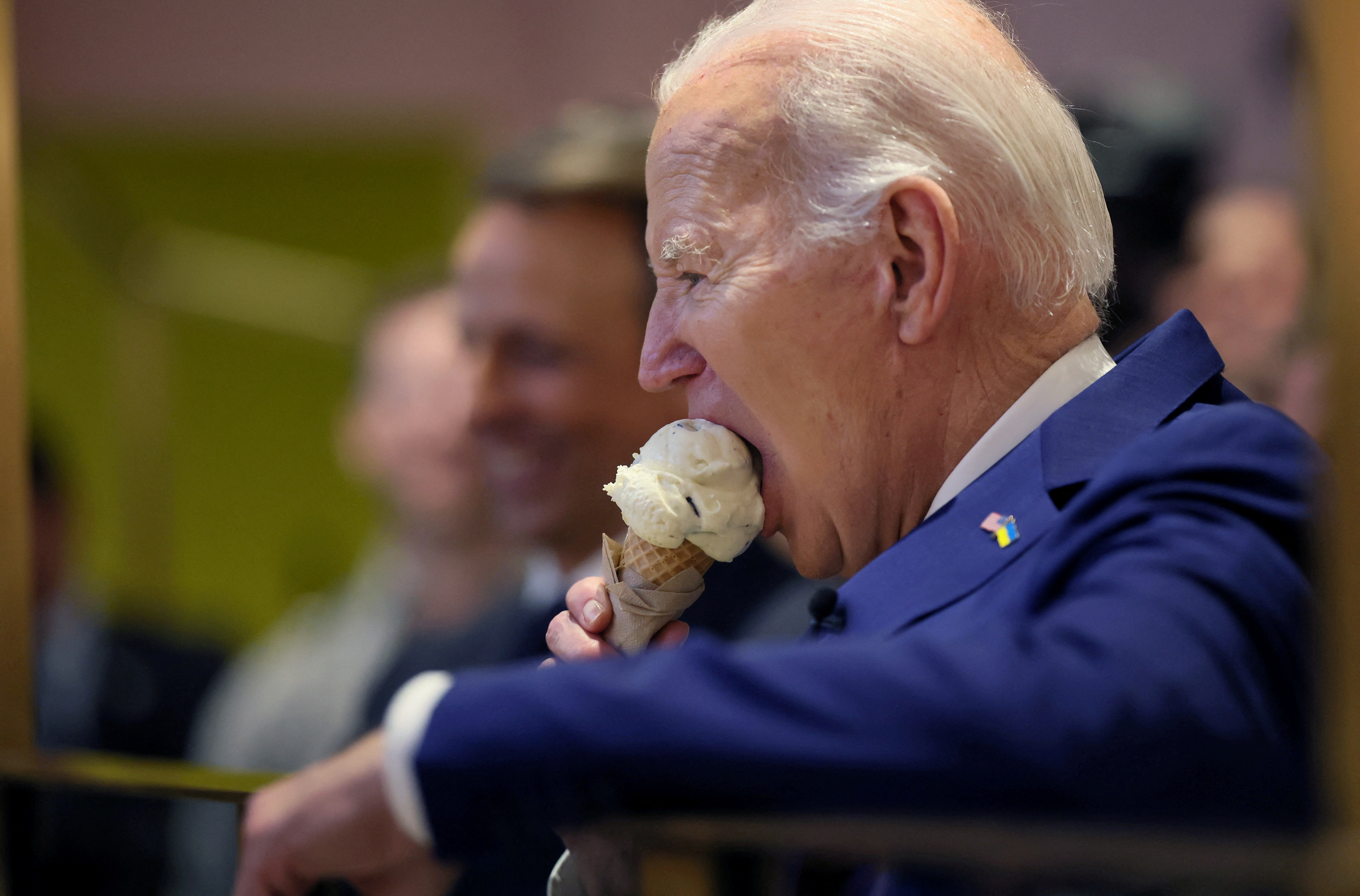 U.S. President Joe Biden bites into his ice cream as he and Seth Meyers visit Van Leeuwen Ice Cream in downtown New York, U.S. February 26, 2024. REUTERS/Leah Millis