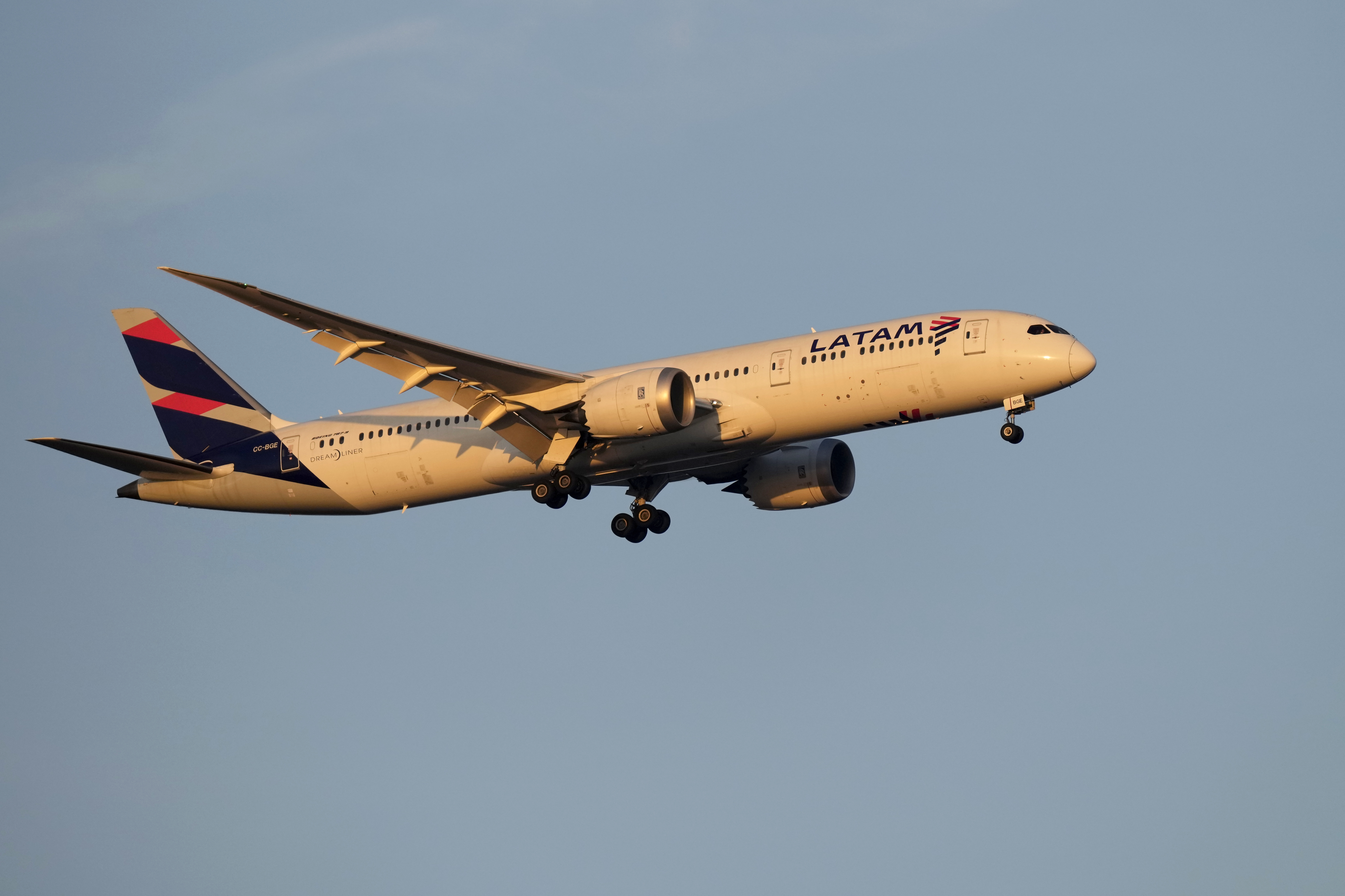 A LATAM Airlines Boeing 787 approaches for landing in Lisbon at sunrise, Tuesday, Oct. 10, 2023. (AP Photo/Armando Franca)