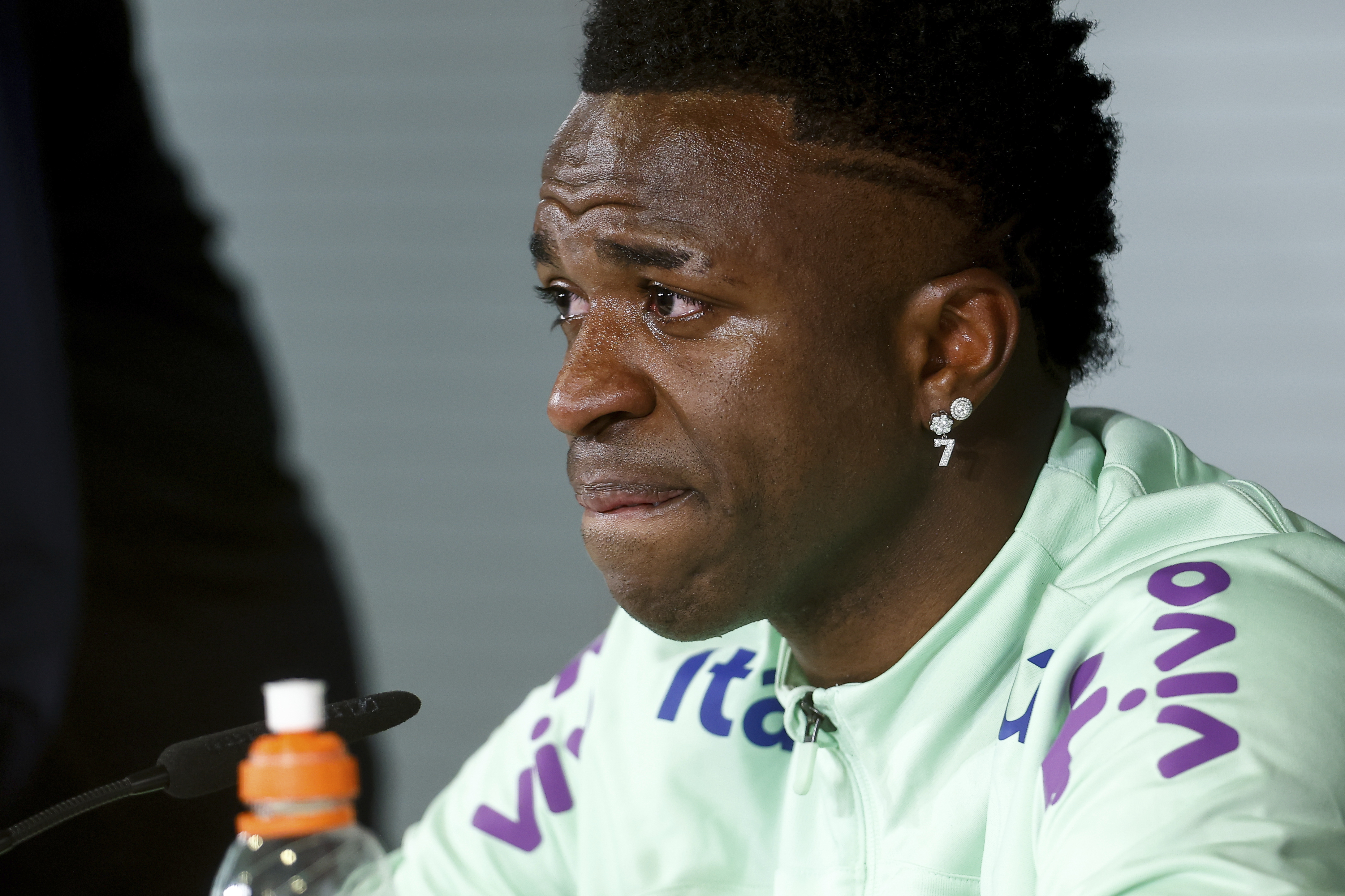 Vinicius Junior cries during a press conference after a training session of the Brazil team ahead of their friendly match against Spain while talking about the racist insults that he has been subjected to in Spain [Oscar J Barroso/AP]