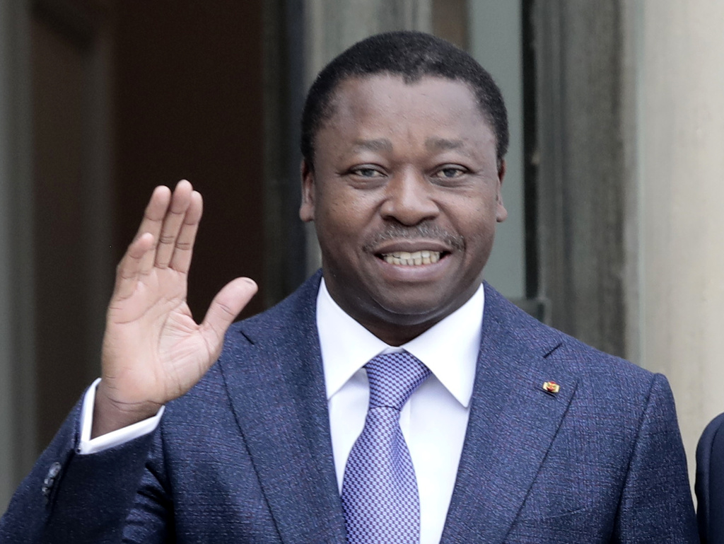 Togo's President Faure Gnassingbe waves before a working lunch at the Elysee Palace in Paris