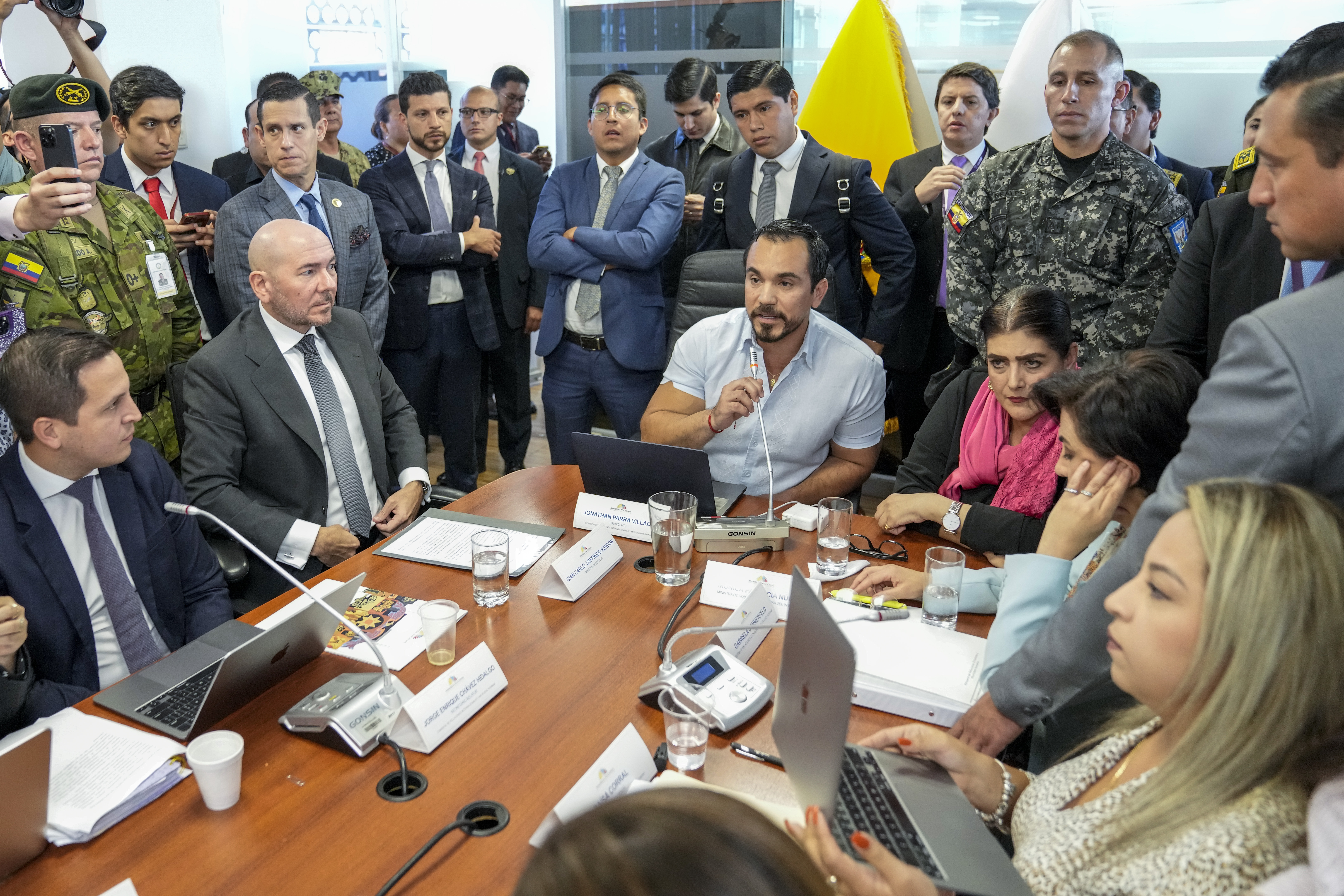 Ecuadorian officials gather around a conference table to discuss a raid on the Mexican embassy in Quito.