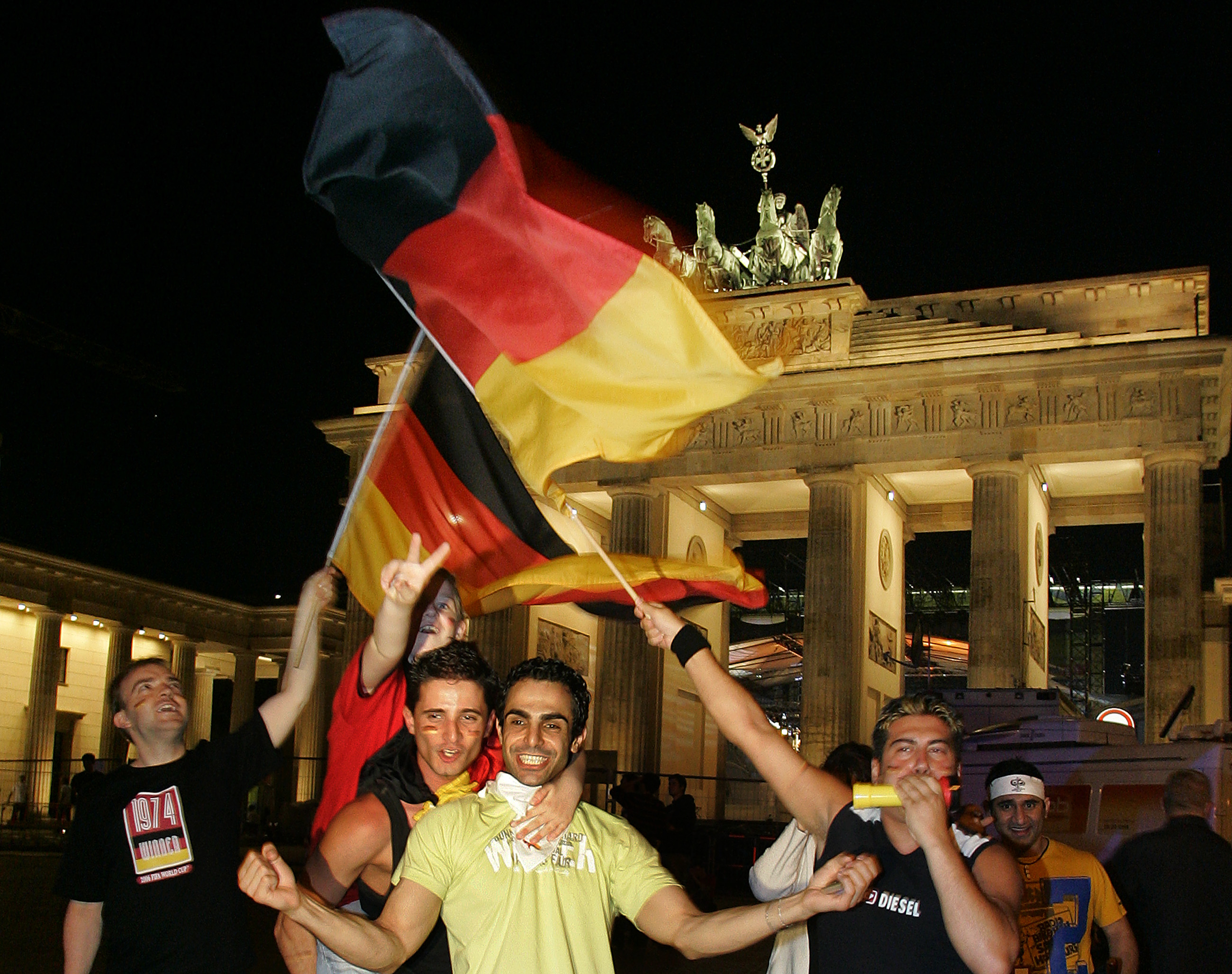Football fans wave flag.