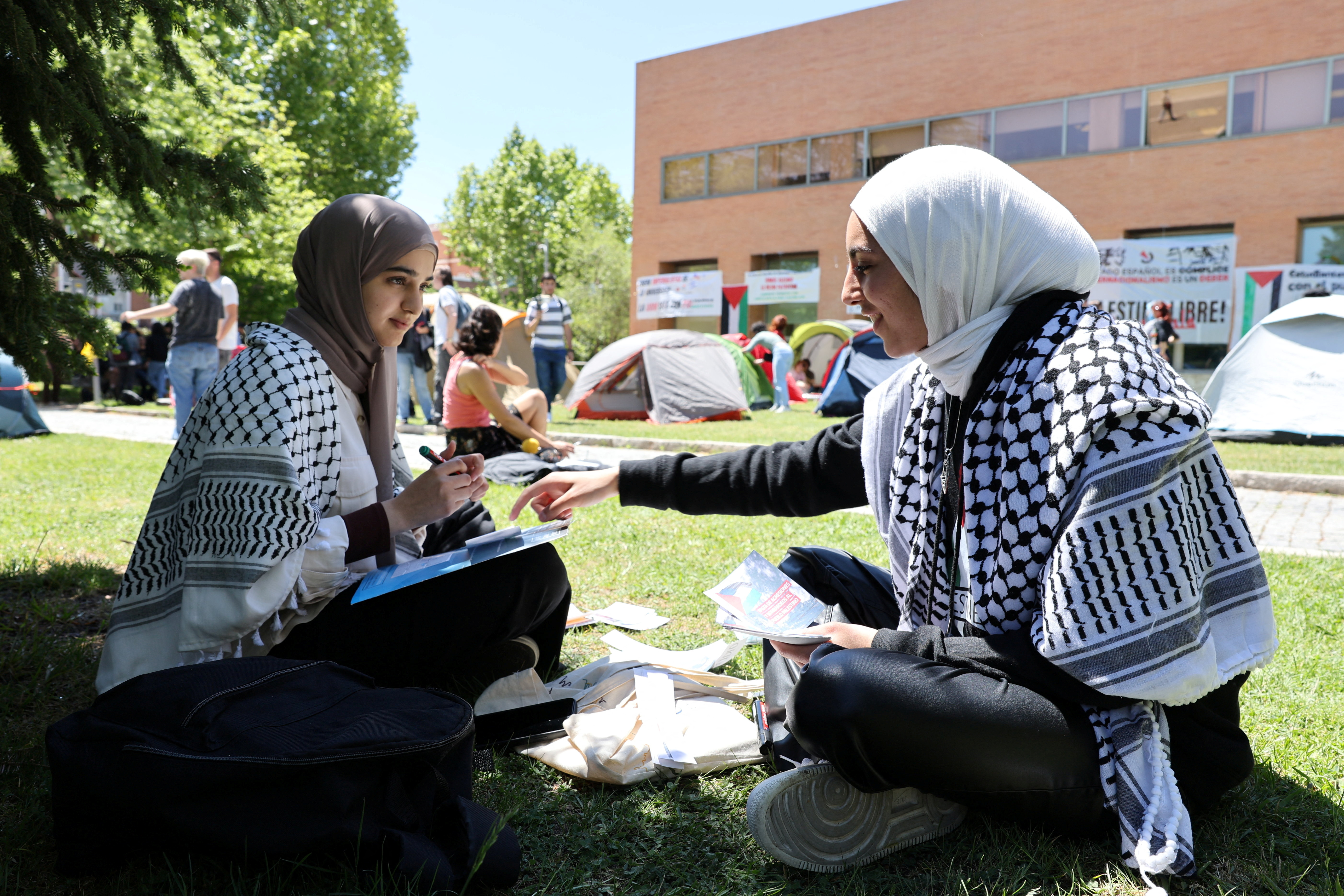 Students of the Complutense University of Madrid make fliers at a pro-Palestinian encampment amid the ongoing conflict between Israel and the Palestinian Islamist group Hamas, in Madrid, Spain, May 7, 2024. REUTERS/Violeta Santos Moura