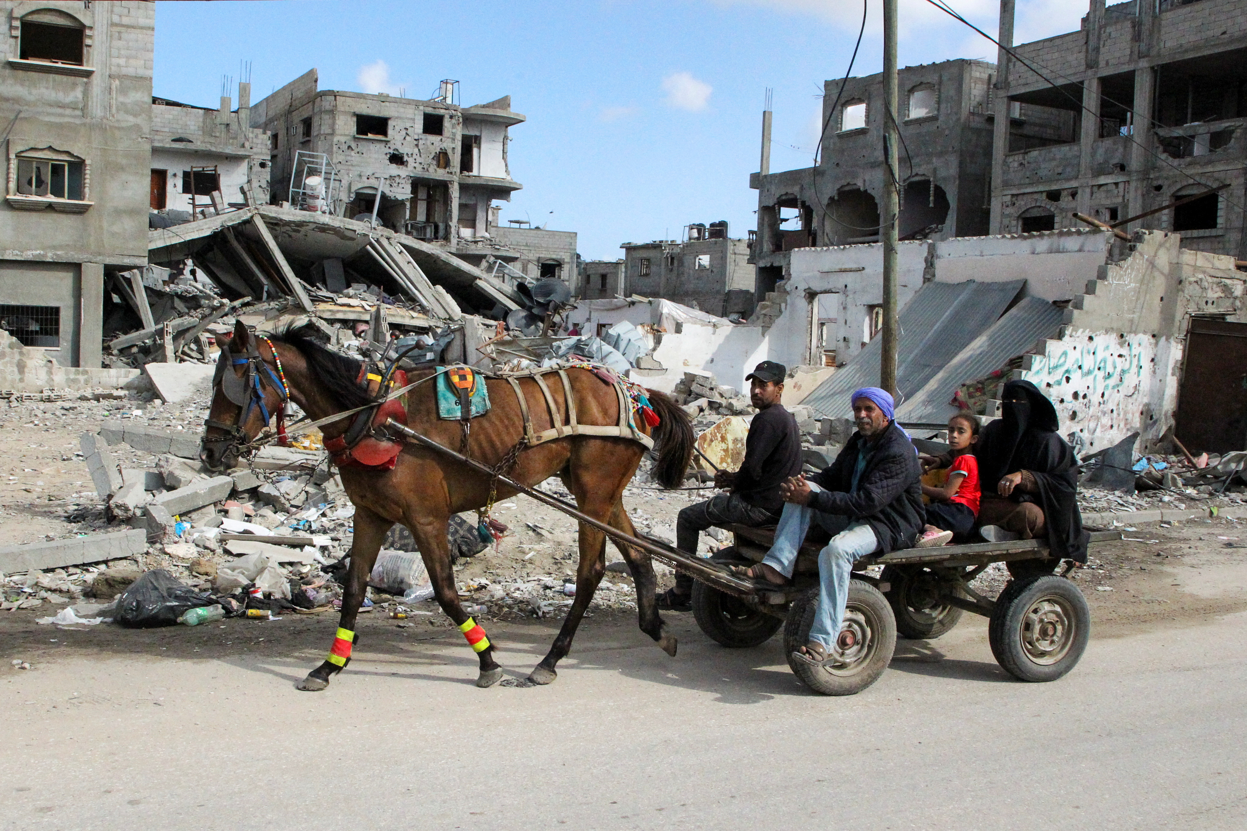 Displaced Palestinians travel in a horse-drawn cart as they flee Rafah, after Israeli forces launched a ground and air operation in the eastern part of the southern Gaza city, amid the ongoing conflict between Israel and Hamas, in Rafah, in the southern Gaza Strip May 12