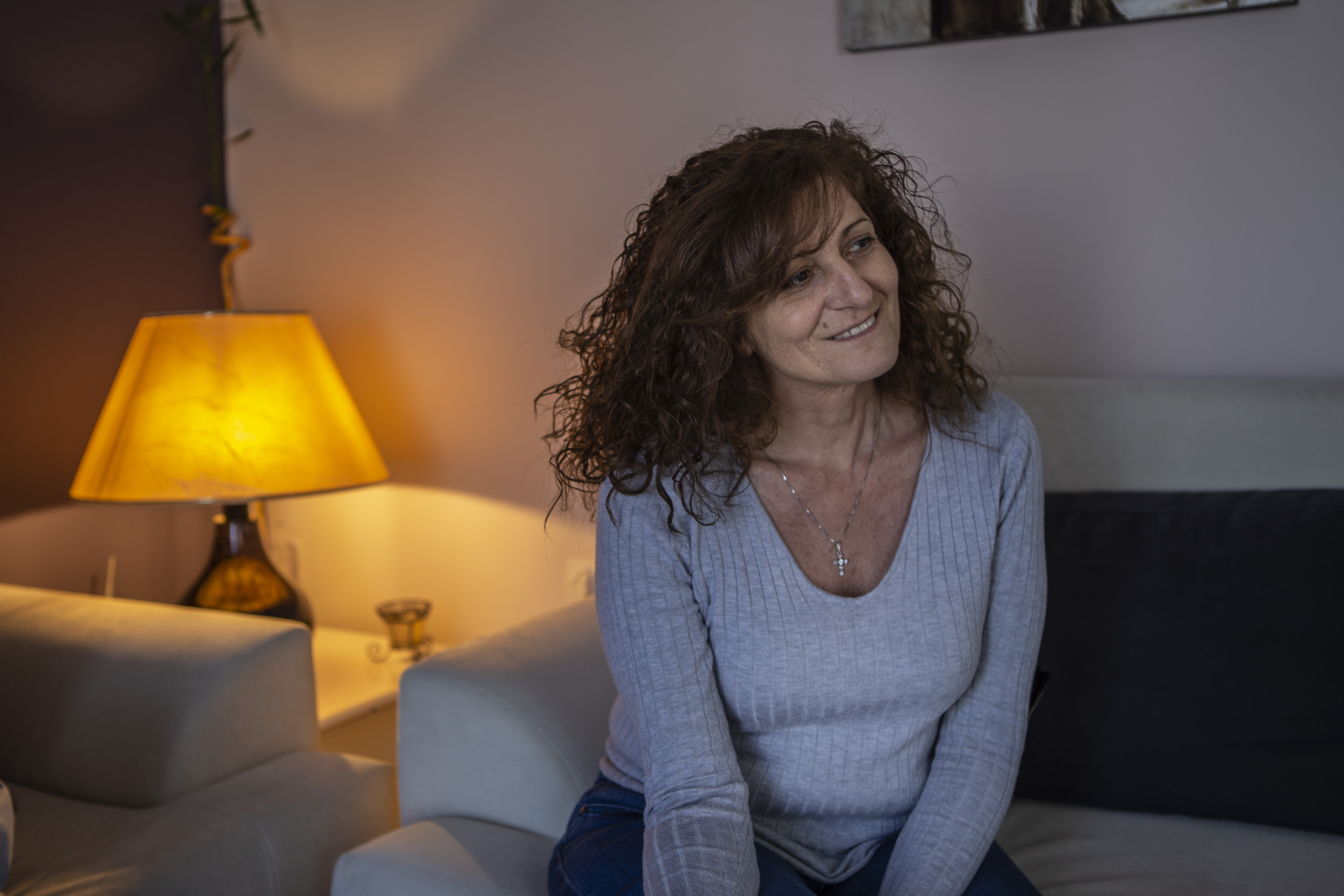 Katerina Kotti, the mother of Dora, sits in the living room of the family's house in Rhodes.