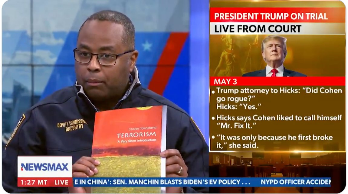 NYPD Deputy Commissioner Kaz Daughtry shows the book titled &#039;Terrorism: A Very Short Introduction&#039; as evidence of some kind of foreign, radicalising influence on student activism [Newsmax/Screengrab]