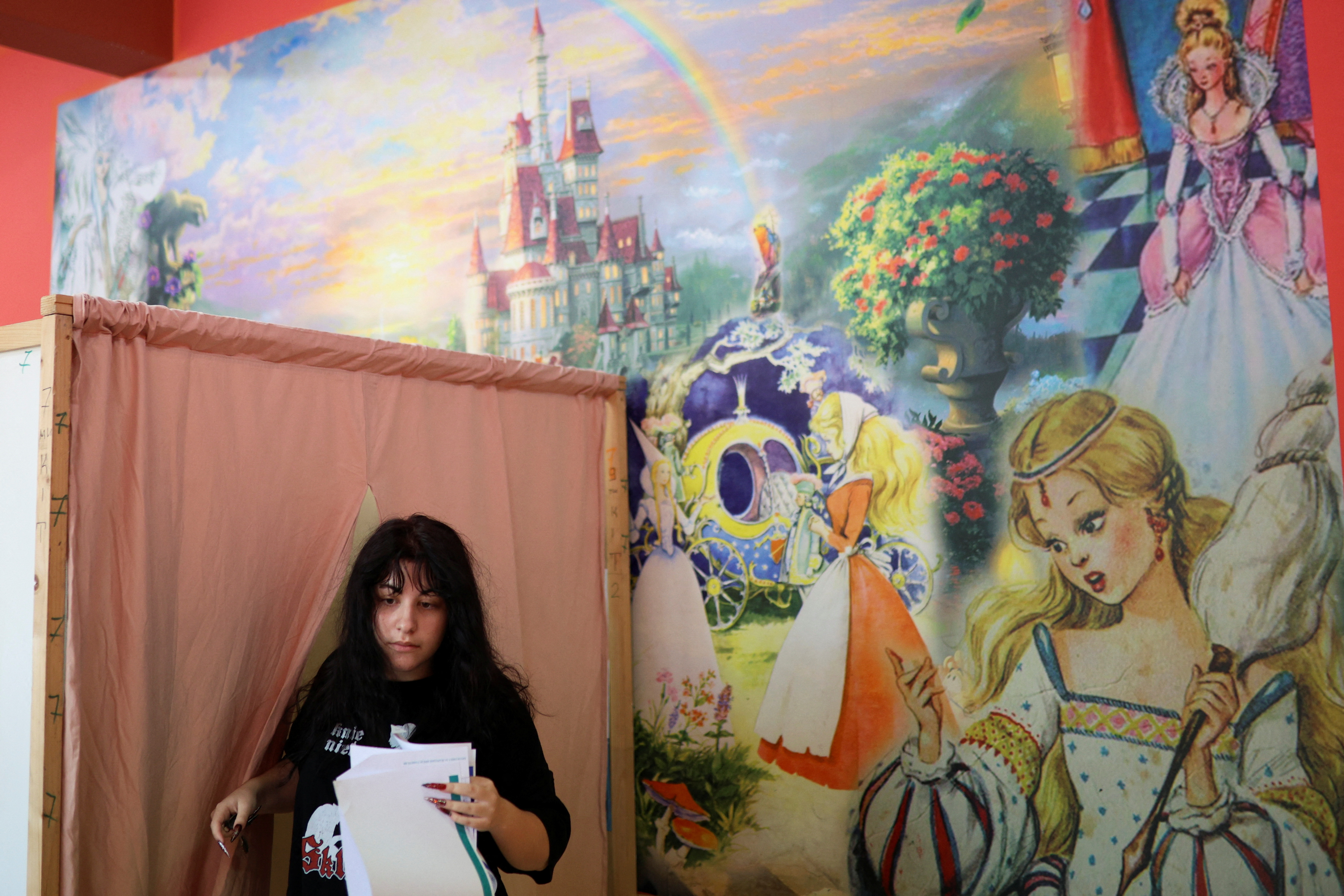 A woman votes at a polling station during snap parliamentary and European Parliament elections in Sofia, Bulgaria, June 9, 2024. REUTERS/Spasiyana Sergieva