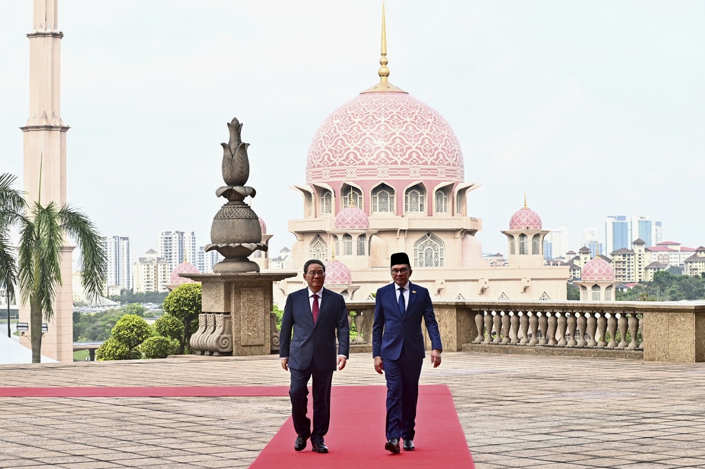 China's Premier Li Qiang, left, walks with Malaysia Prime Minister Anwar Ibrahim as he arrives at Putrajaya, Malaysia