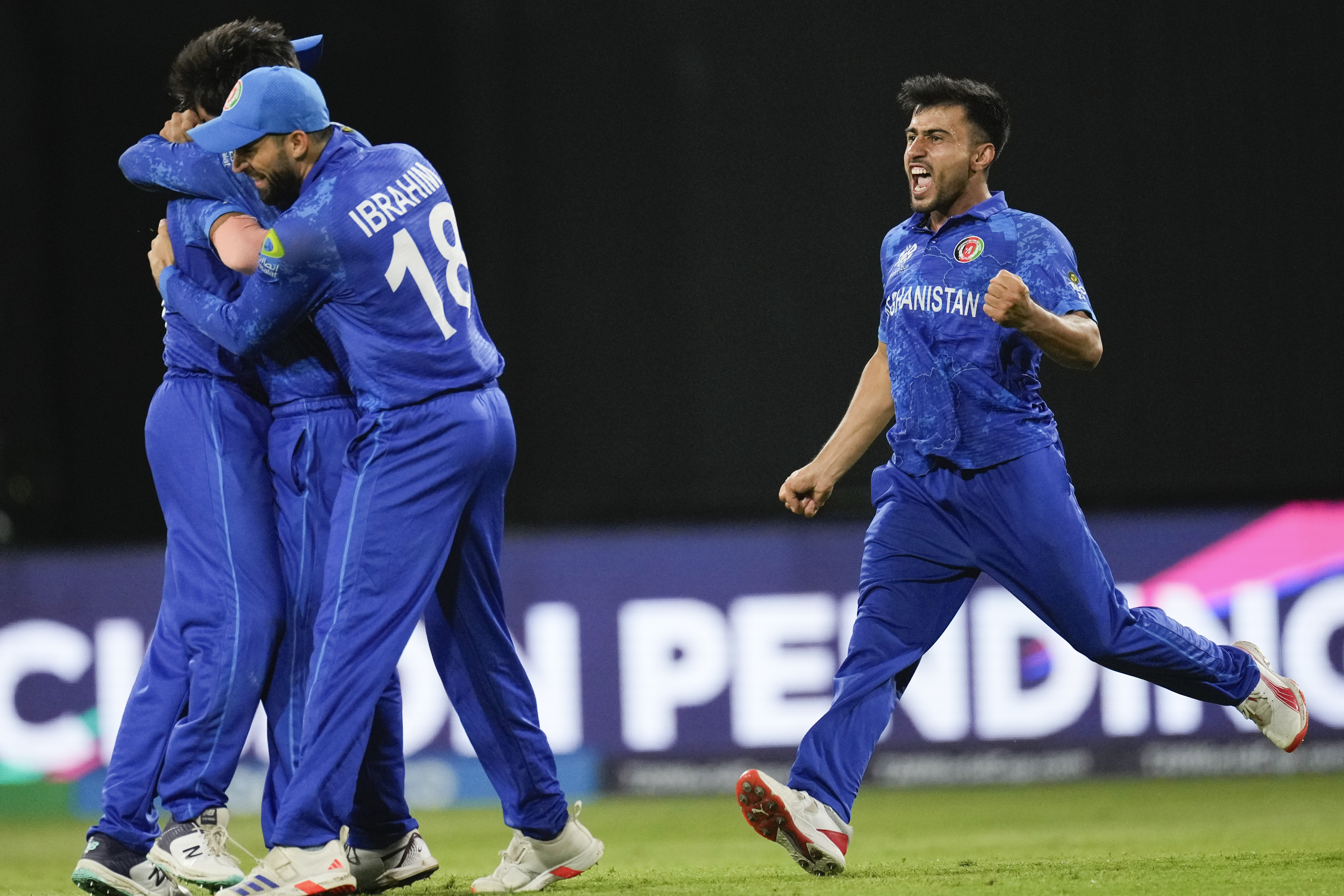 Afghanistan players celebrate after defeating Bangladesh by eight runs in their men's T20 World Cup cricket match at Arnos Vale Ground, Kingstown, Saint Vincent and the Grenadines, Monday, June 24, 2024. (AP Photo/Ricardo Mazalan)