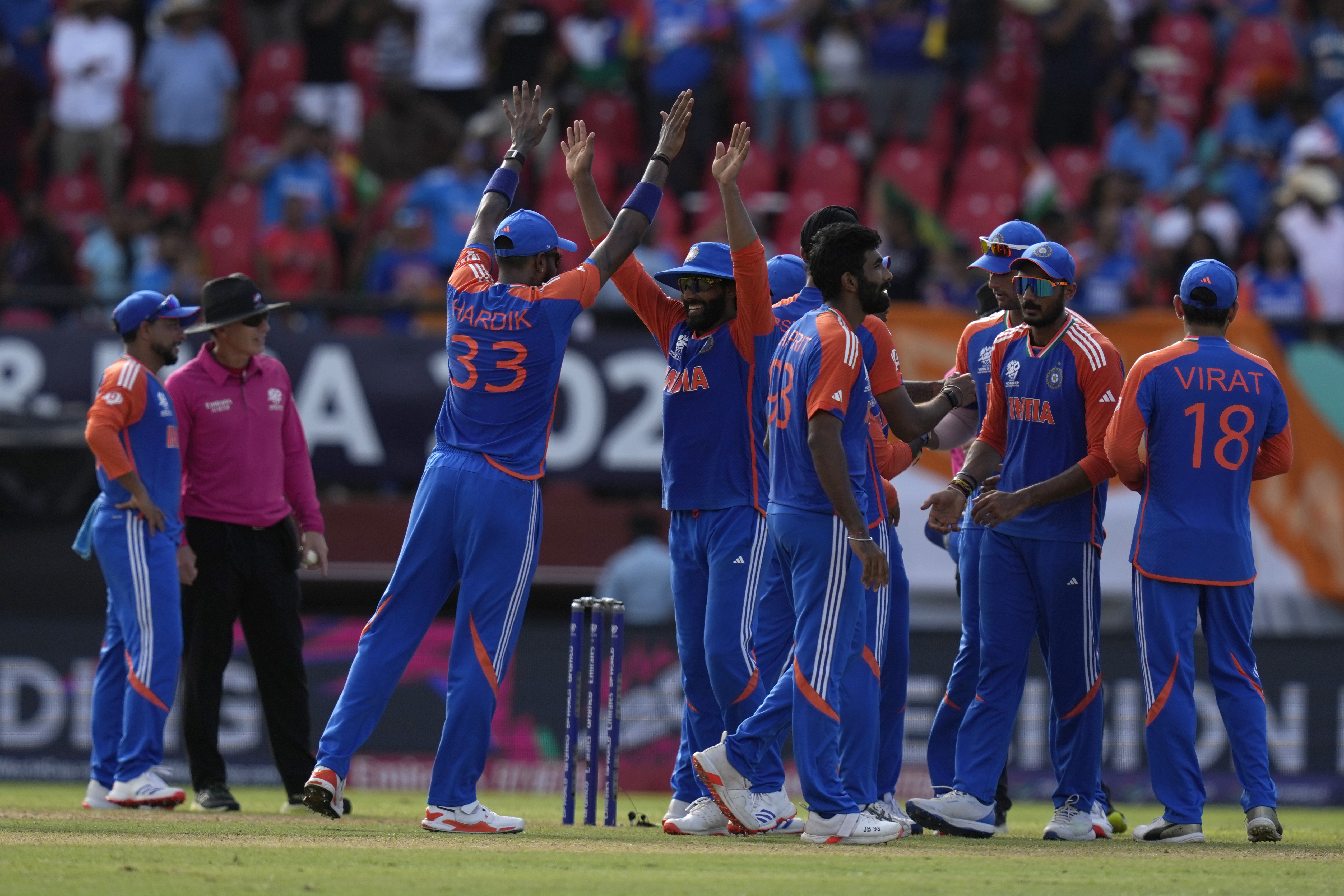 Indian players celebrate a dismissal during the ICC Men's T20 World Cup second semifinal cricket match between England and India at the Guyana National Stadium in Providence, Guyana, Thursday, June 27, 2024. (AP Photo/Ramon Espinosa)