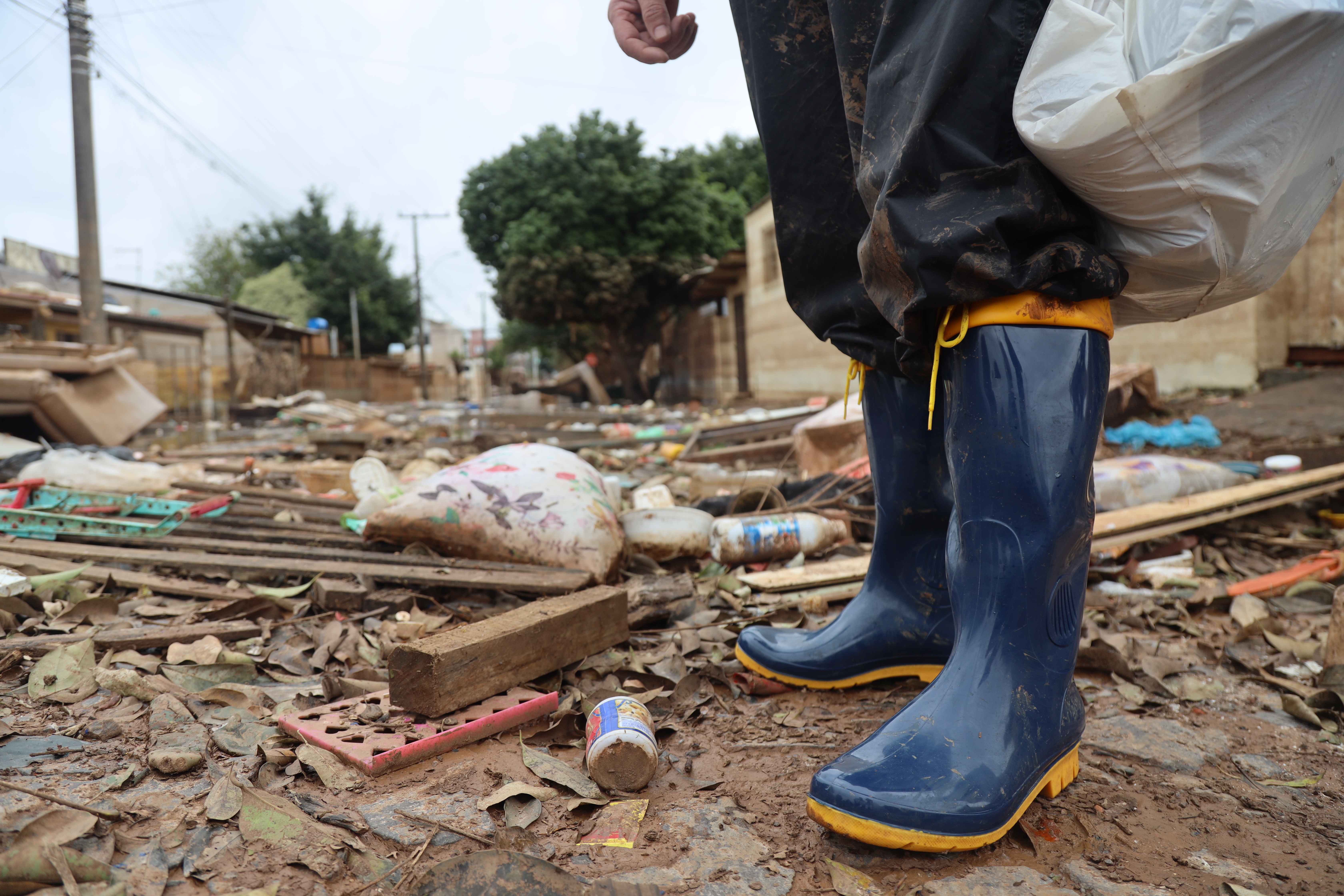 A pair of Wellington rain-boots are seen standing amid the rubble of a flooded street