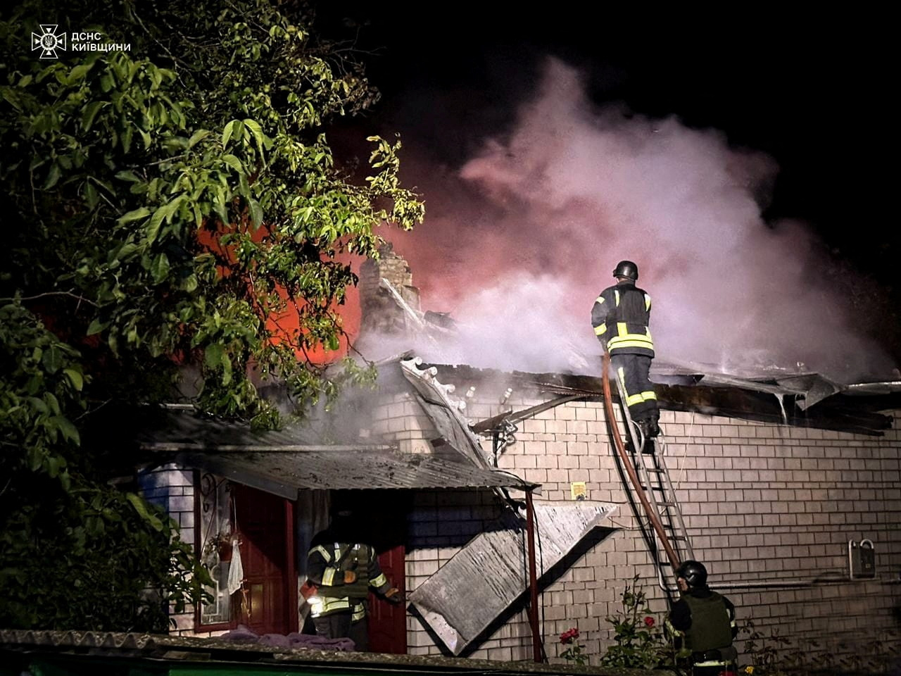 Firefighters work at a site of a residential building damaged during a Russian drone strike, amid Russia's attack on Ukraine, in Kyiv region