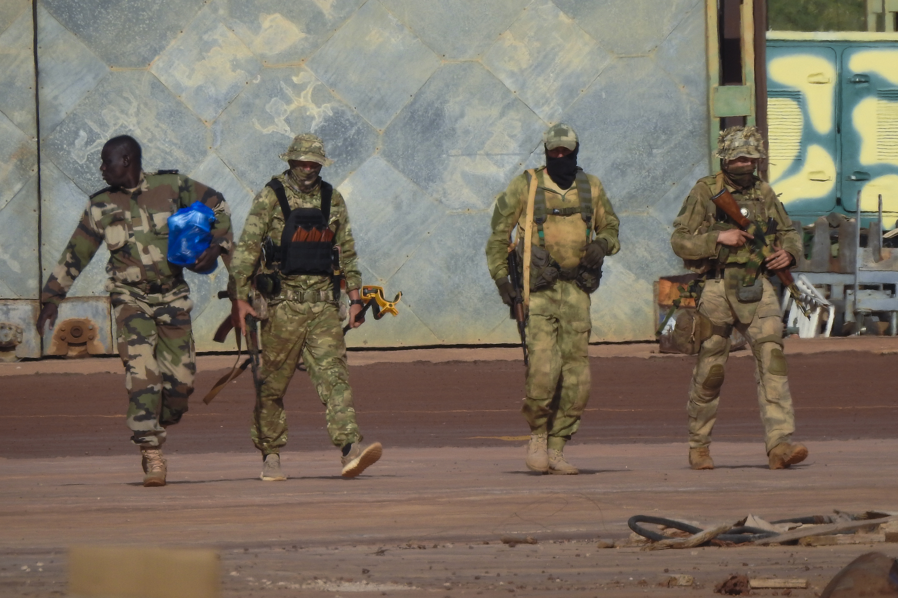 Three Russian mercenaries in military fatigues.