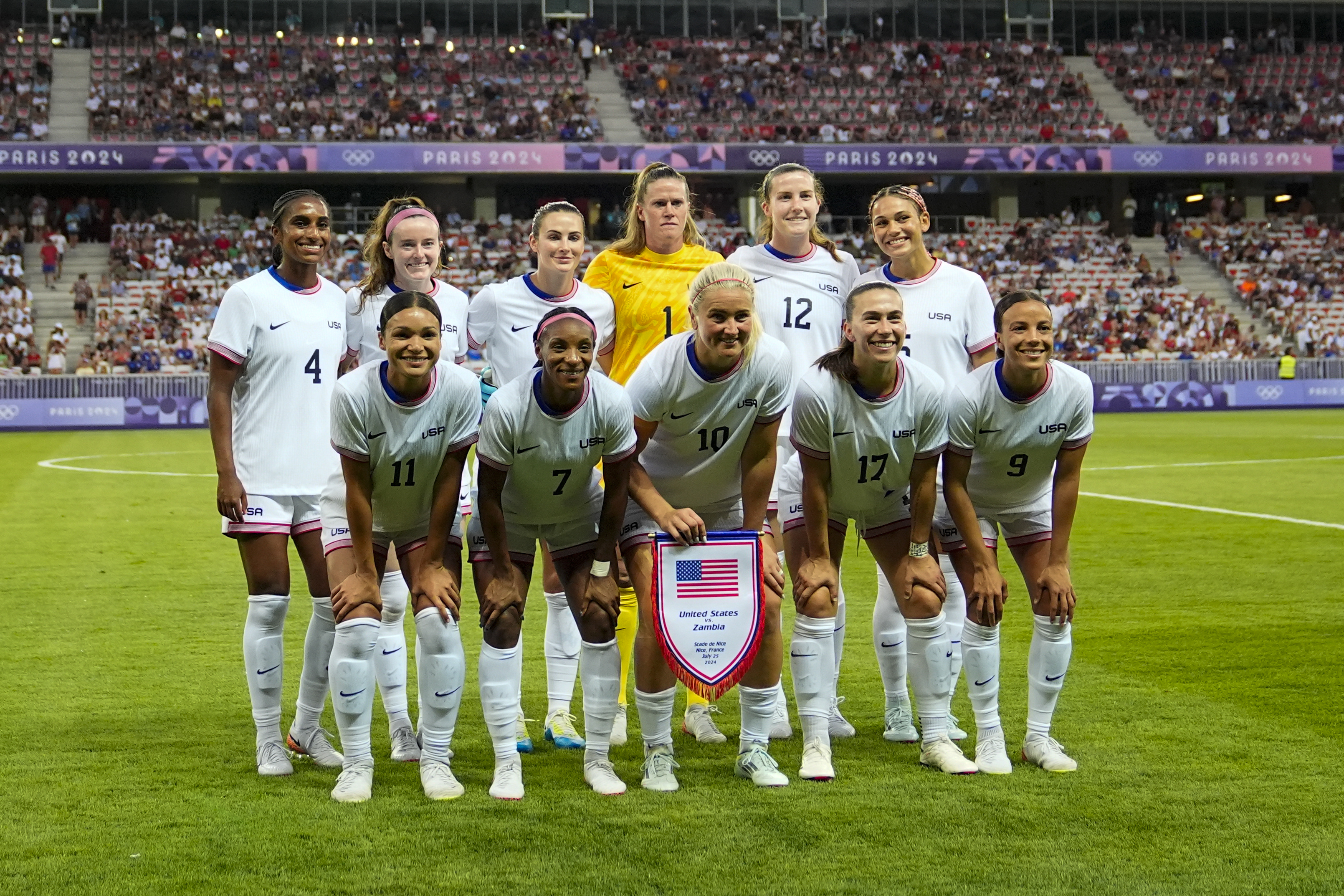 The United States starting squad posses for photographers prior to a women's group B match between the United States and Zambia at Nice Stadium at the 2024 Summer Olympics, Thursday, July 25, 2024, in Nice, France. (AP Photo/Julio Cortez)
