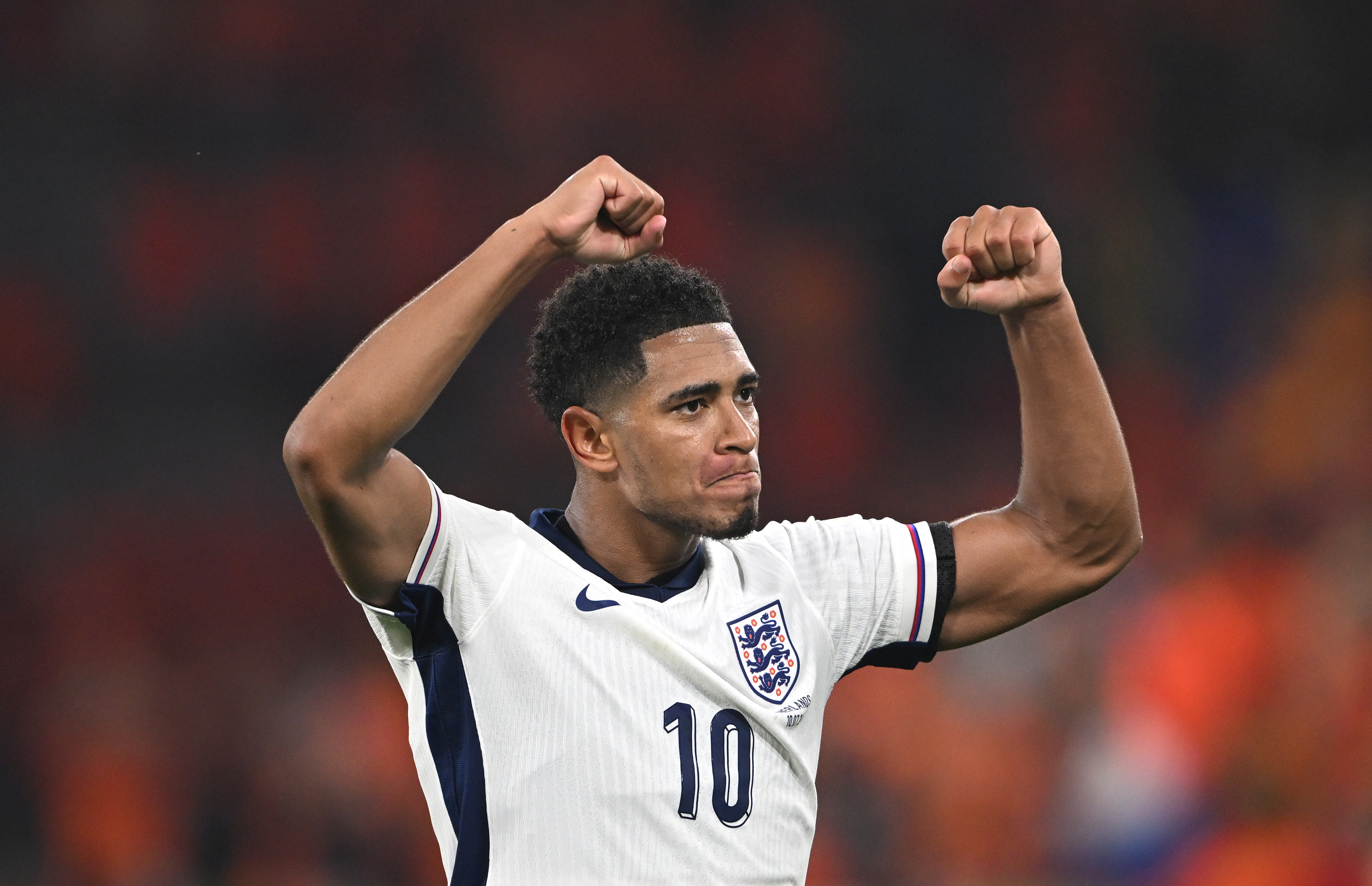 Football player raises arms.