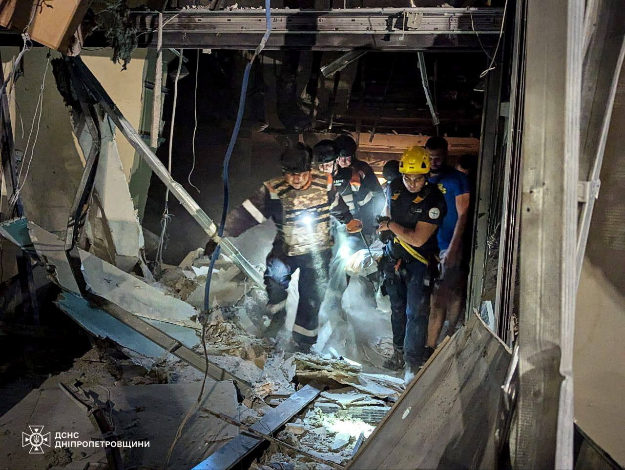 Rescuers carrying a body bag from a ruined building after a Russian missile attack in Kryvyi Rih