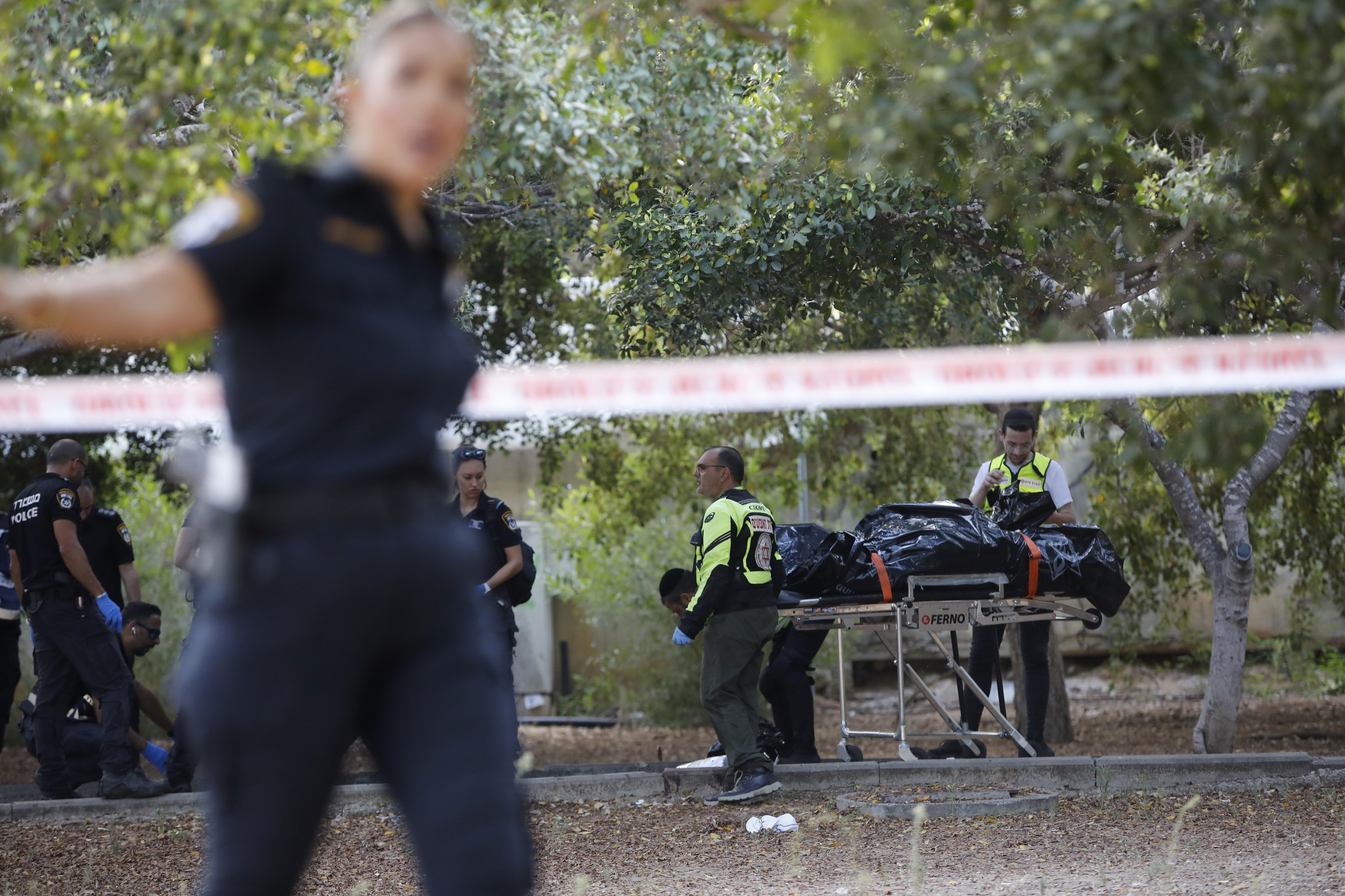 Israeli Police remove the body of a woman from the site of a stabbing attack in Holon, Israel, Sunday, Aug. 4, 2024 [AP Photo/Tomer Appelbaum]
