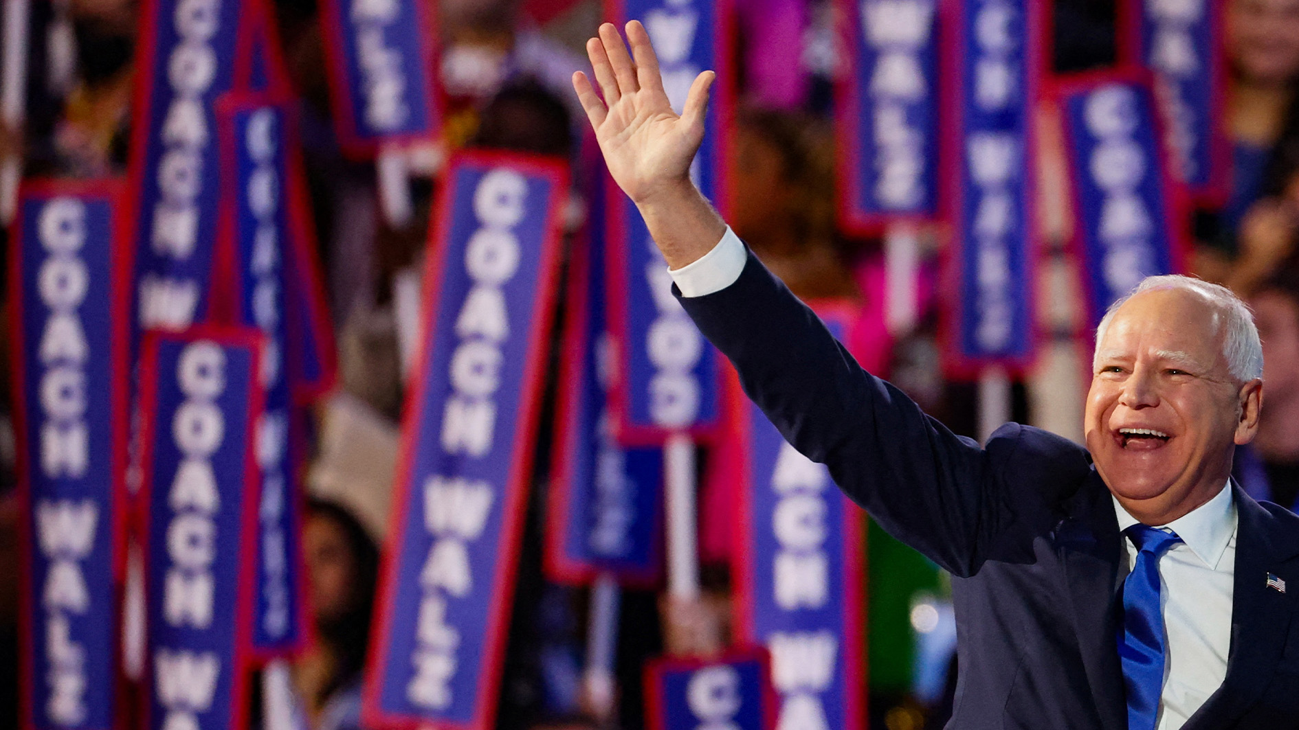 Image of Democratic VP candidate Tim Walz waving to the crowds at the Democratic National Convention in Chicago. (Al Jazeera)