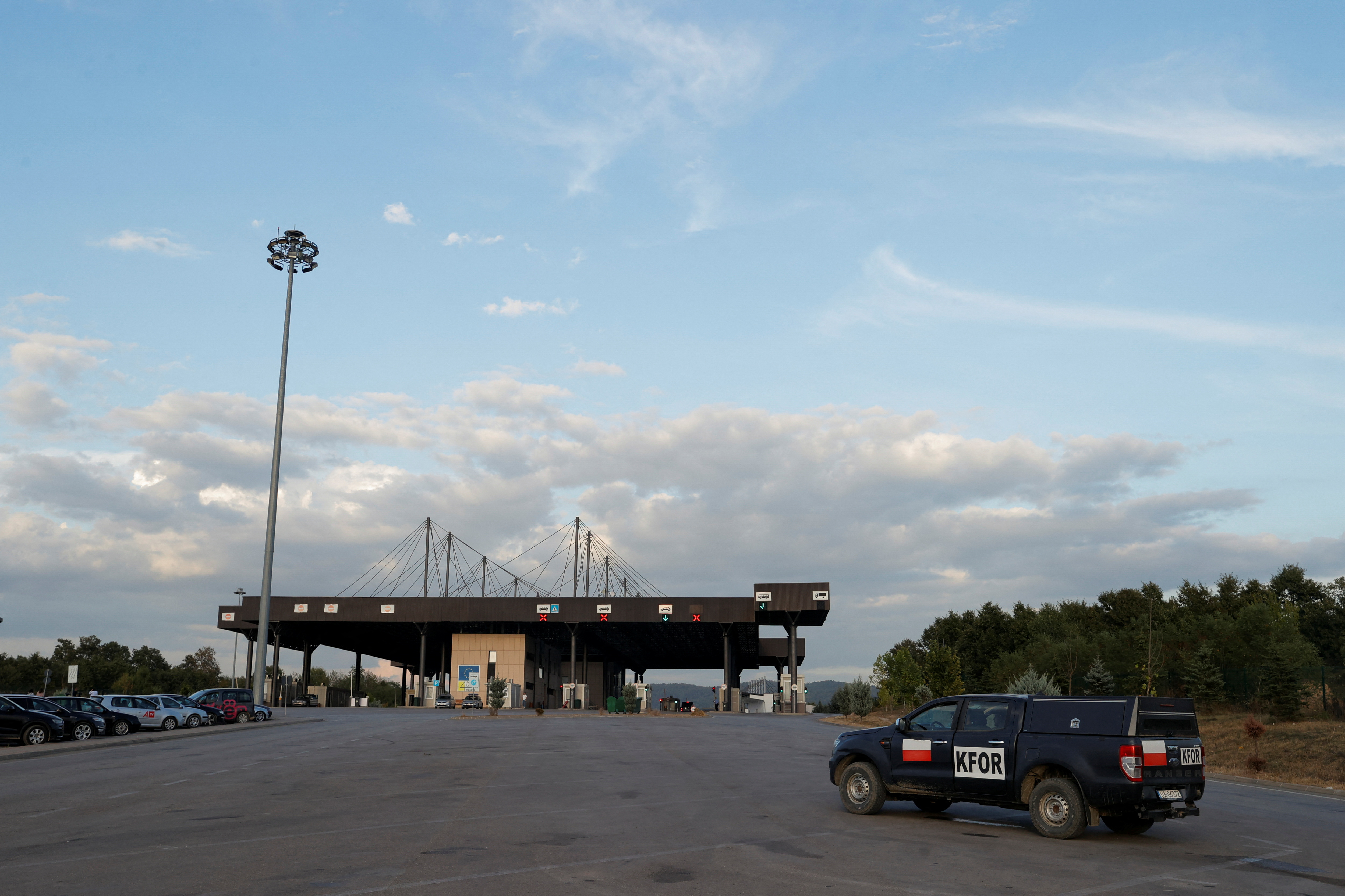 A vehicle of the NATO-led peacekeeping mission is seen at the main Kosovo-Serbia border crossing in Merdare, Kosovo September 6, 2024. REUTERS/Valdrin Xhemaj